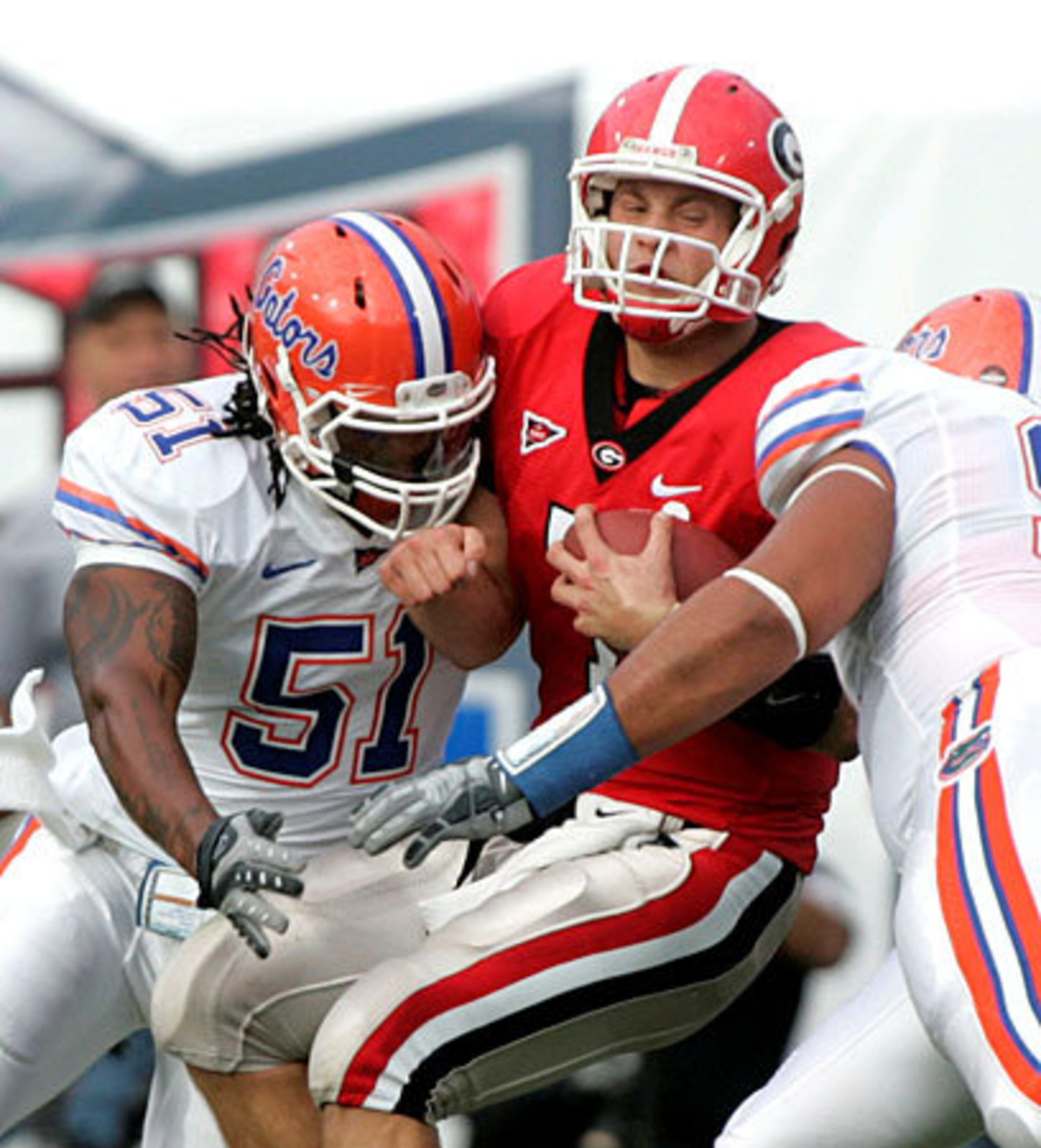 Georgia quarterback Matthew Stafford, center, is sacked by Florida linebacker Brandon Spikes, left, and defensive tackle Terron Sanders.