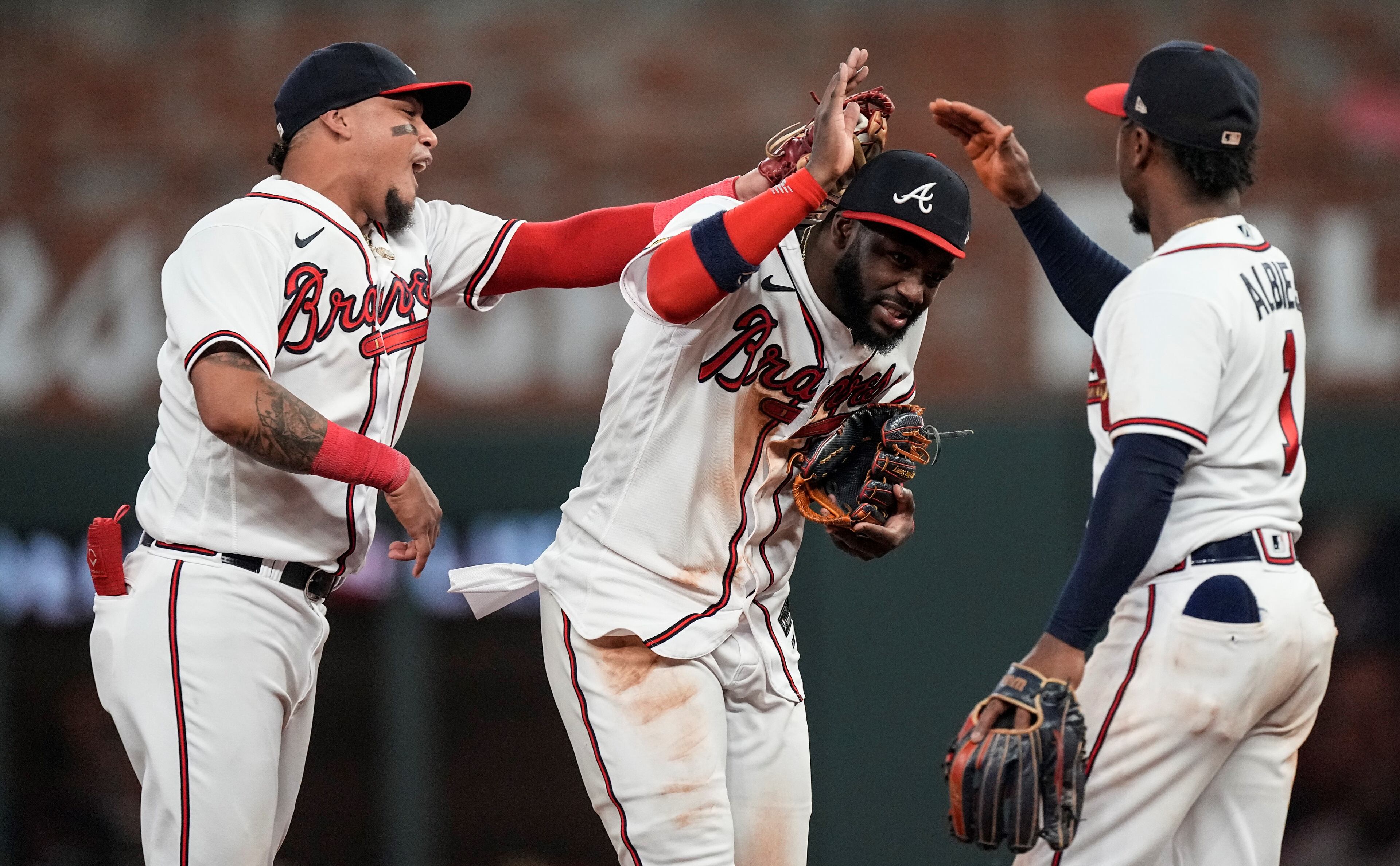 Michael Harris II (center) celebrates with teammates Orlando Arcia (left) and Ozzie Albies after defeating the New York Mets 7-5 Wednesday, June 7, 2023, in Atlanta. (AP Photo/John Bazemore)