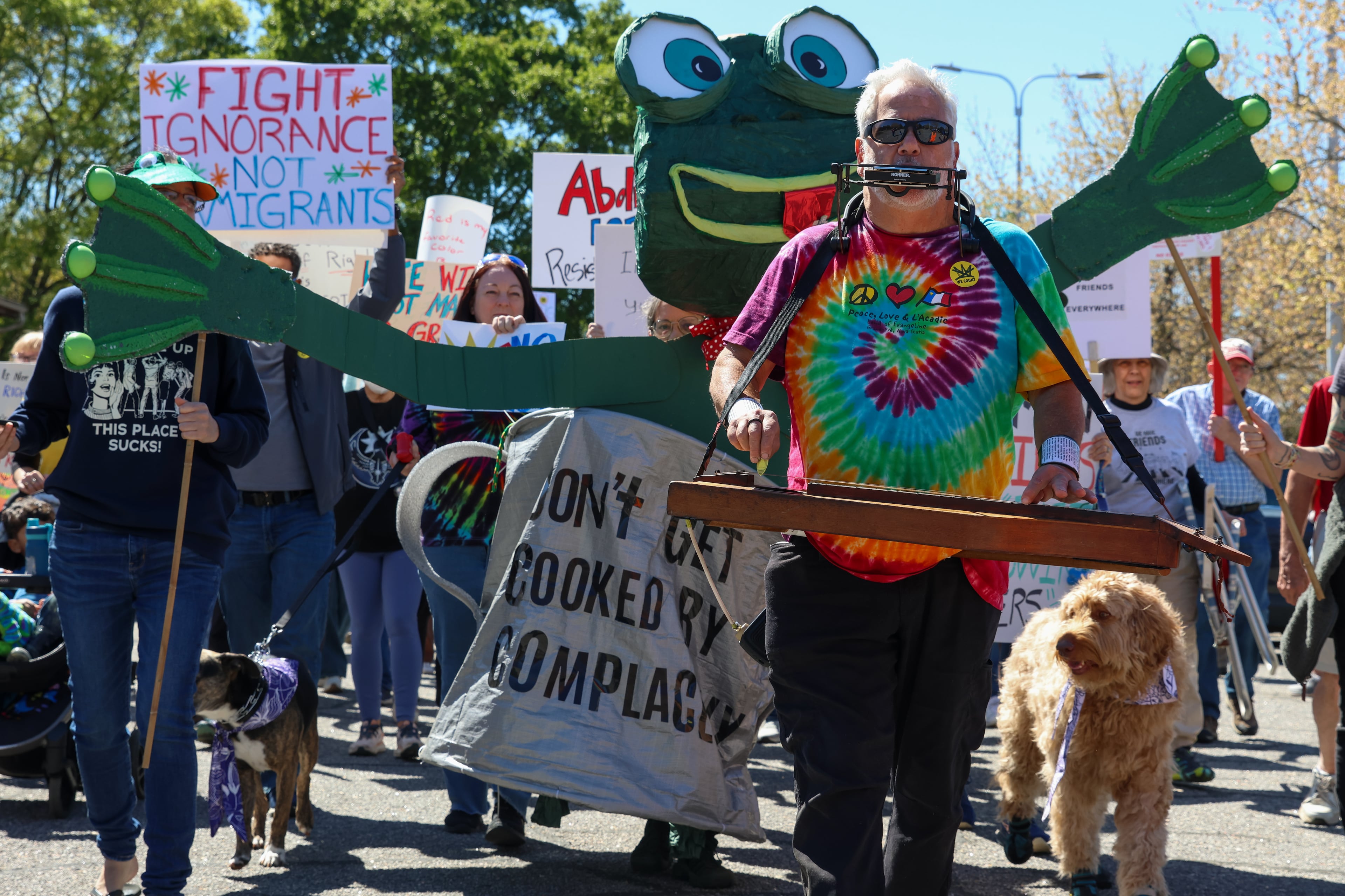 People march in Bishop Park in Athens on Saturday, March 28, 2026. Protesters gathered in 10 different locations around Georgia’s Congressional District 10, leading up to a “Democracy Fair” at Bishop Park as part of a nationwide day of “No Kings” demonstrations. Organizers estimate that a few thousand people participated, many of them first-time protesters. (C.J. Bartunek for the AJC)
