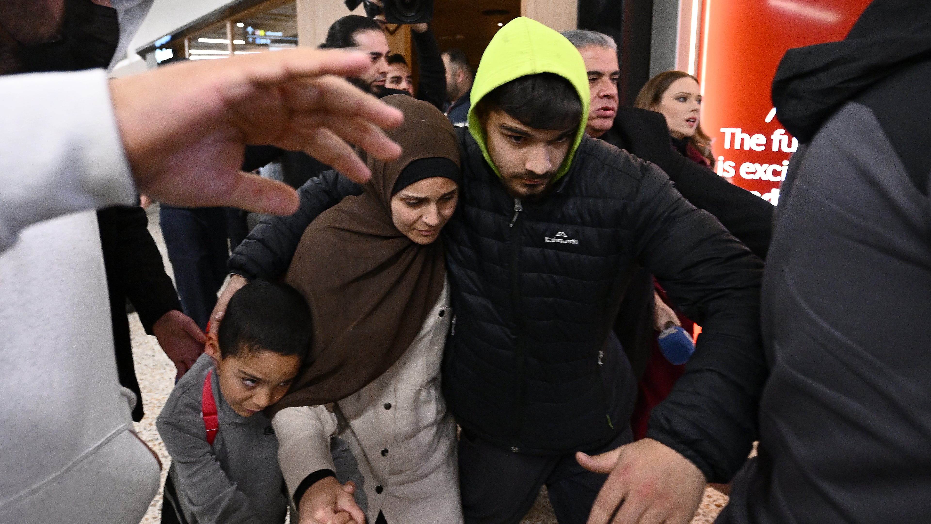 FILE - A group of supporters surround a woman and child with alleged ties to the Islamic State as they arrive at Melbourne international Airport, in Melbourne, Australia, Thursday, May 7, 2026. (Joel Carrett/AAP Image via AP, File)