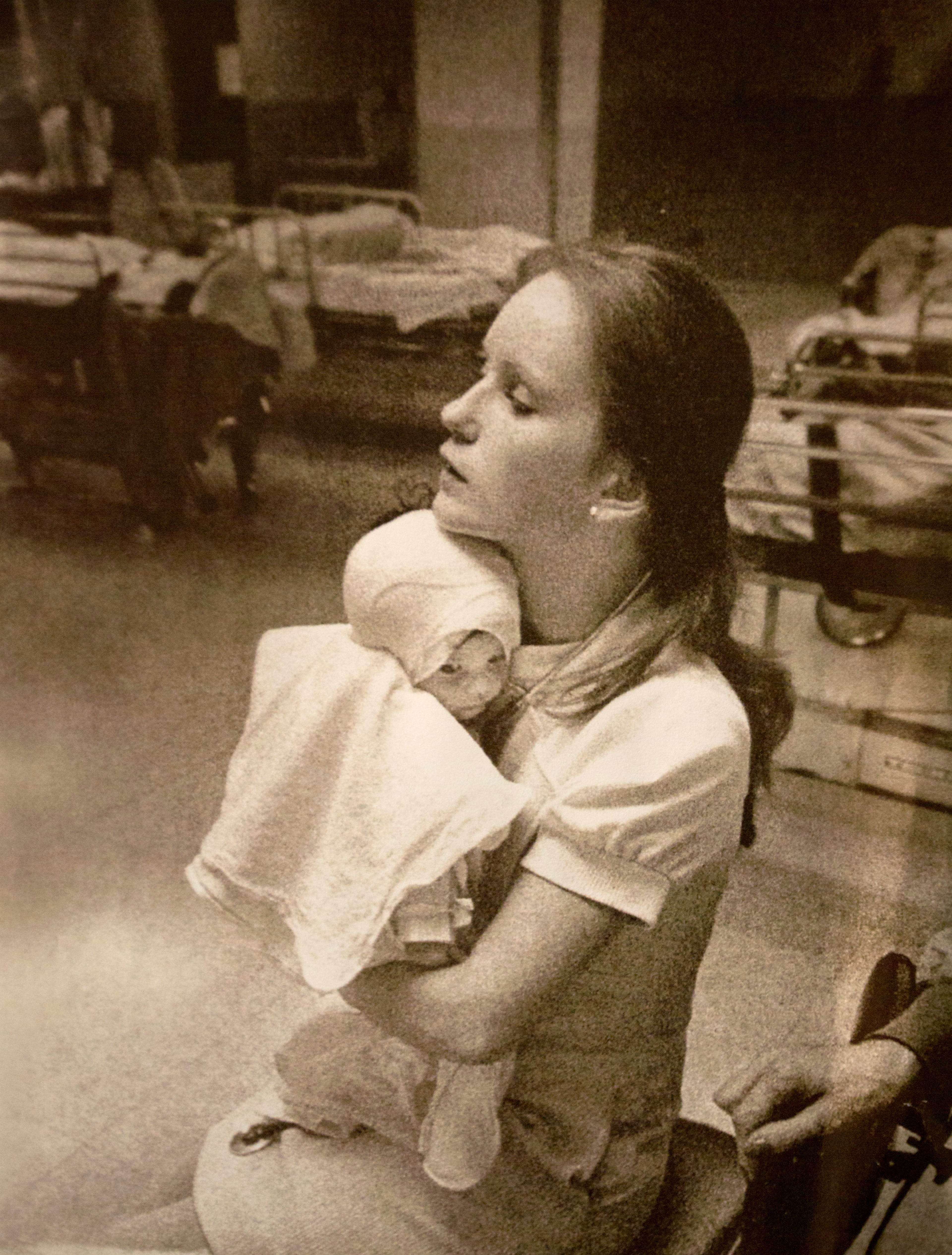 In this photo taken in 1977 and provided by Albany Medical Center, nurse Susan Berger cuddles infant Amanda Scarpinati, who had been severely burned by a steam vaporizer at home, in the pediatric unit at Albany Medical Center in Albany, N.Y. Scarpinati kept the hospital’s annual report that published the photo and was comforted by the picture when she was bullied for her burn scars as a child. She recently used social media to learn Berger’s identity so she could thank her for her loving care. The two women were reunited at the hospital on Tuesday.