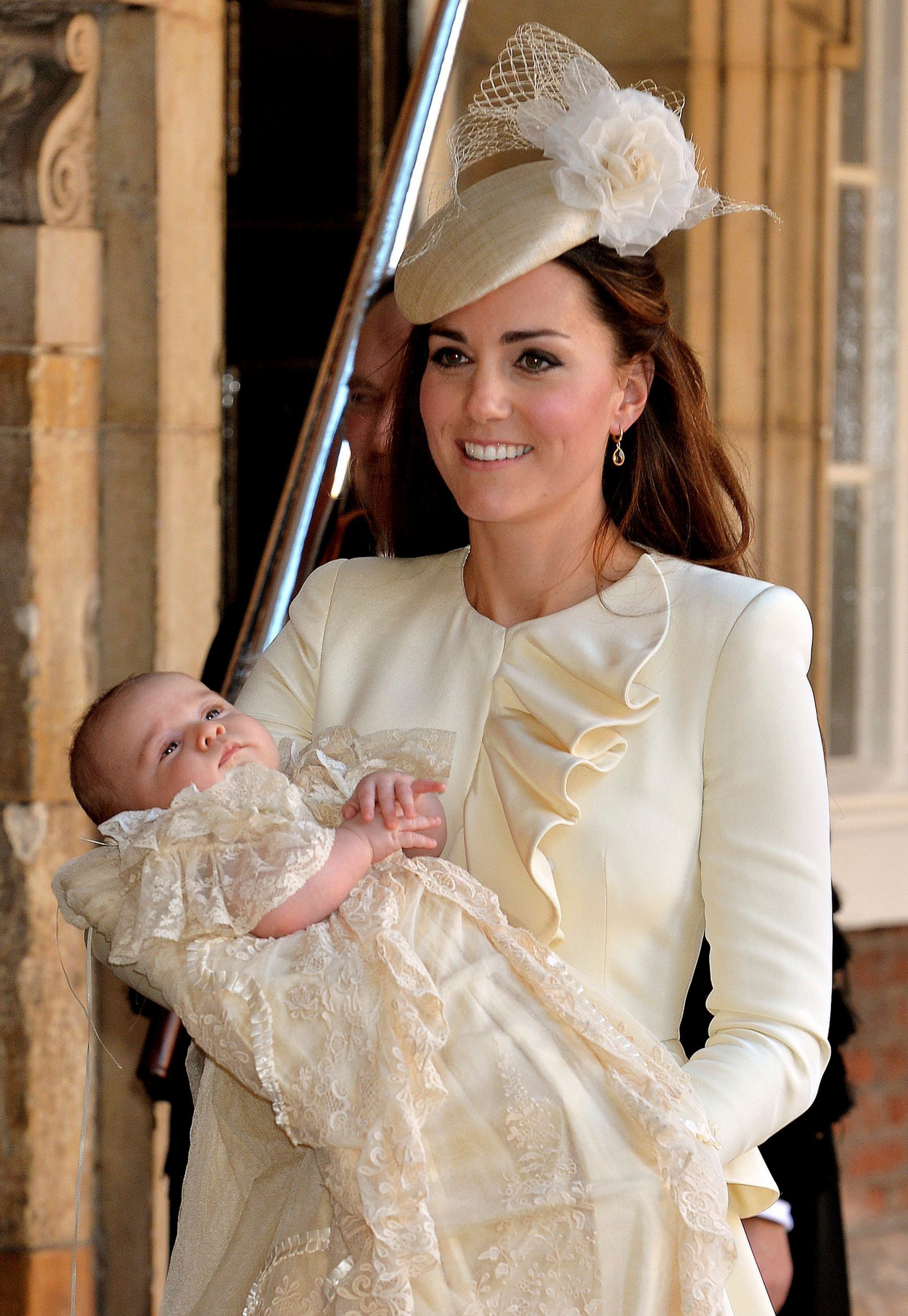 Kate Duchess of Cambridge carries her son Prince George after his christening at the Chapel Royal in St James's Palace in London, Wednesday Oct. 23, 2013. The prince was christened Wednesday with water from the River Jordan at a rare four-generation gathering of the royal family in London. (AP Photo/John Stillwell/Pool)