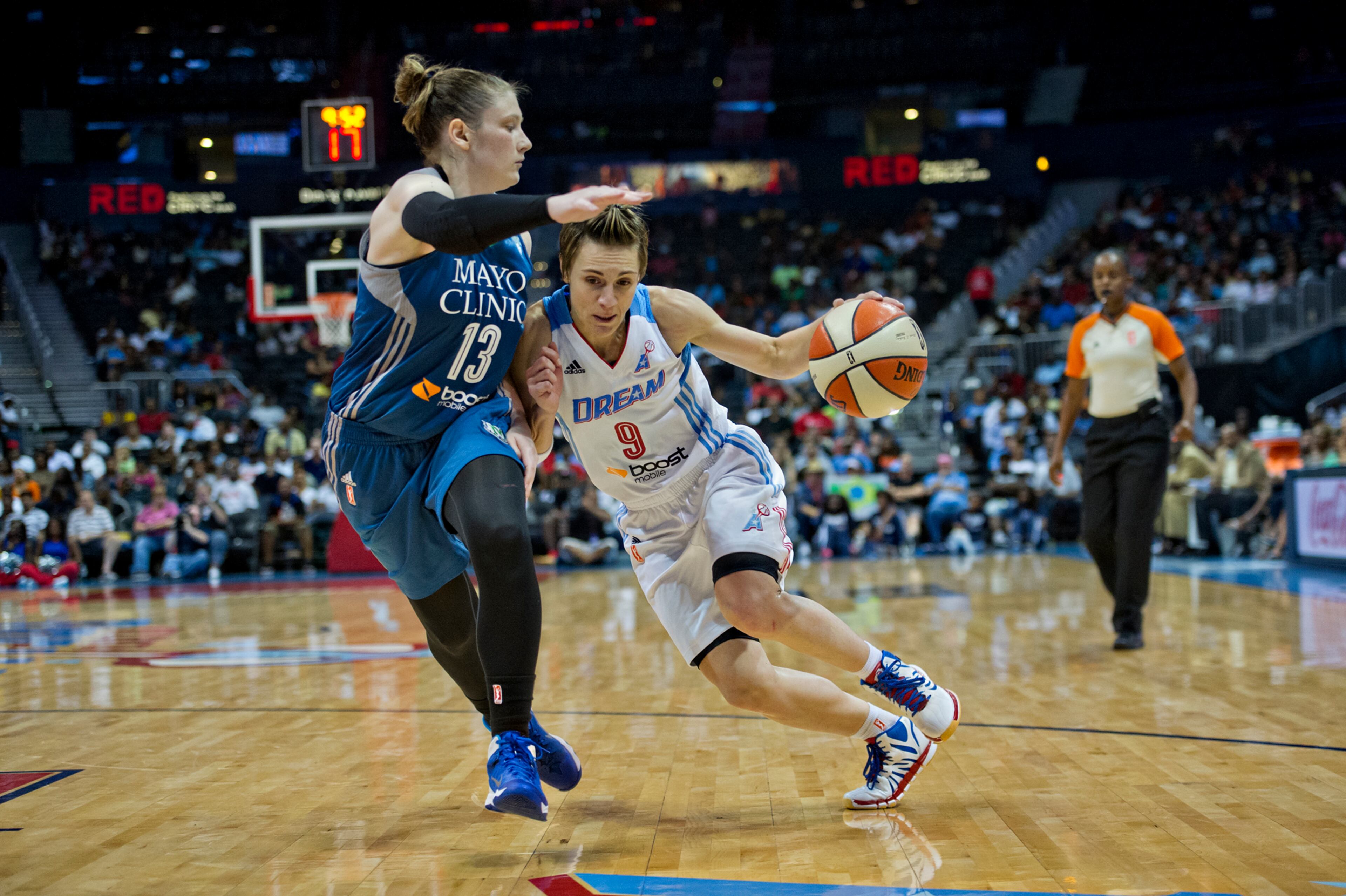 Atlanta's Celine Dumerc (9) drives past Minnesota's Lindsay Whalen (13) during their game at Philips Arena in Atlanta on Friday, June 13, 2014. The Dream defeated the Lynx 85-82.