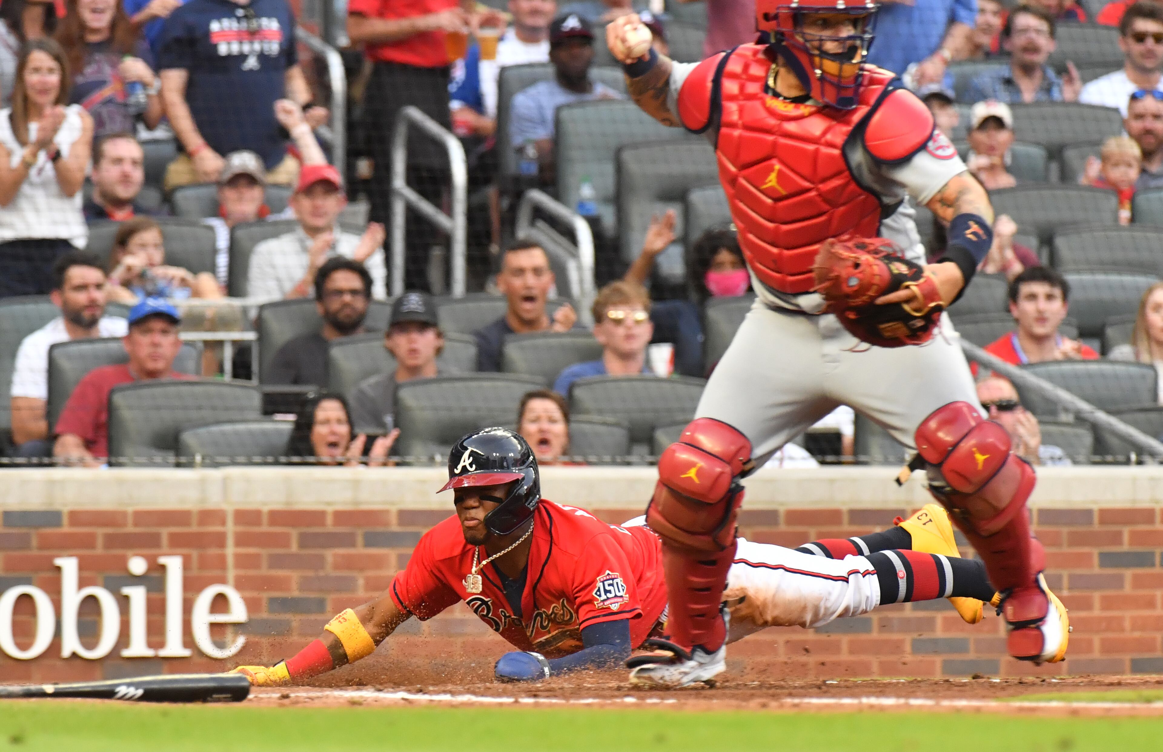 Braves right fielder Ronald Acuna Jr. (13) scores past St. Louis Cardinals catcher Yadier Molina on an RBI double by Freddie Freeman in the second inning. (Hyosub Shin / Hyosub.Shin@ajc.com)