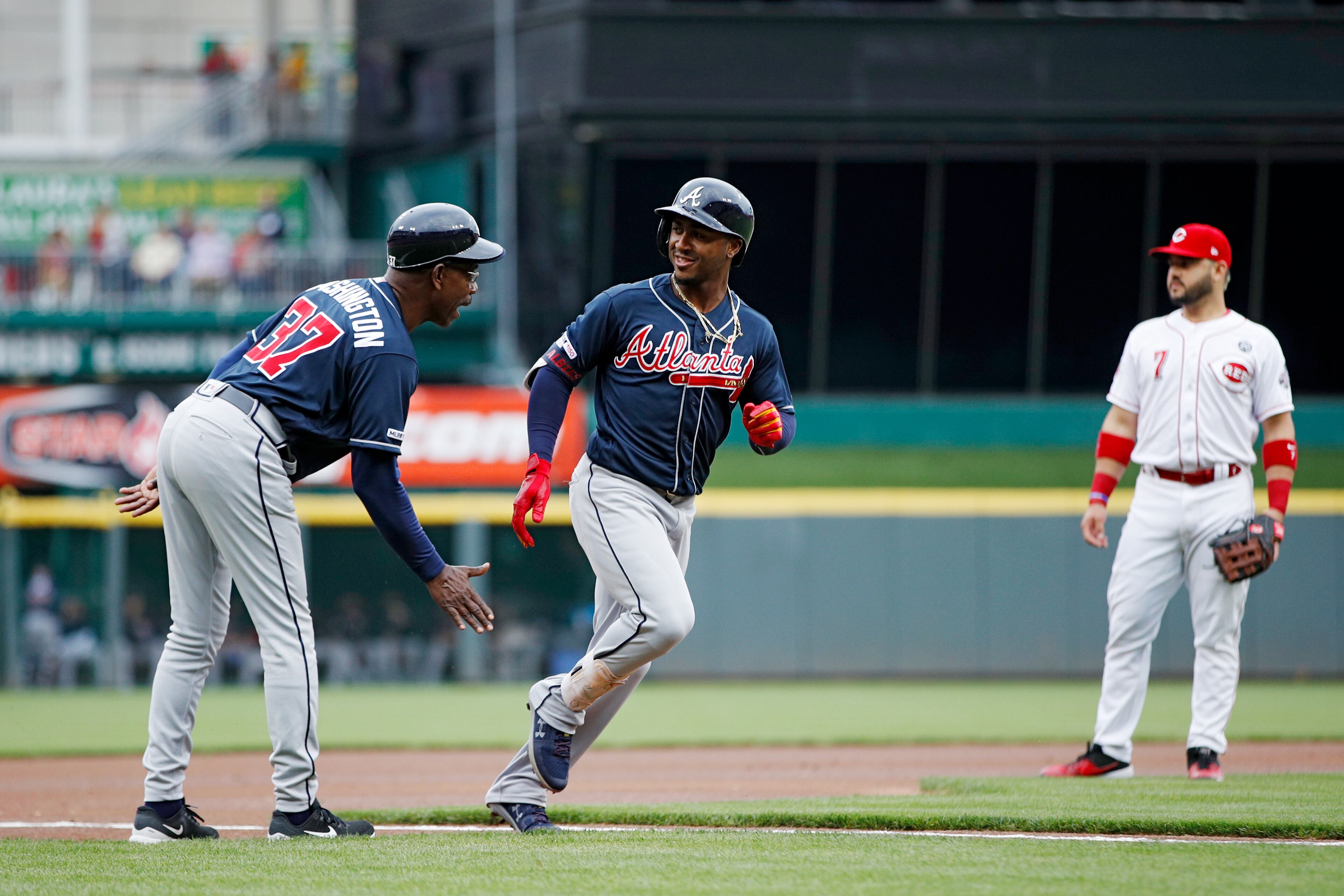 CINCINNATI, OH - APRIL 24: Ozzie Albies #1 of the Atlanta Braves gets a hand from third base coach Ron Washington #37 after hitting a solo home run in the first inning against the Cincinnati Reds at Great American Ball Park on April 24, 2019 in Cincinnati, Ohio. (Photo by Joe Robbins/Getty Images)