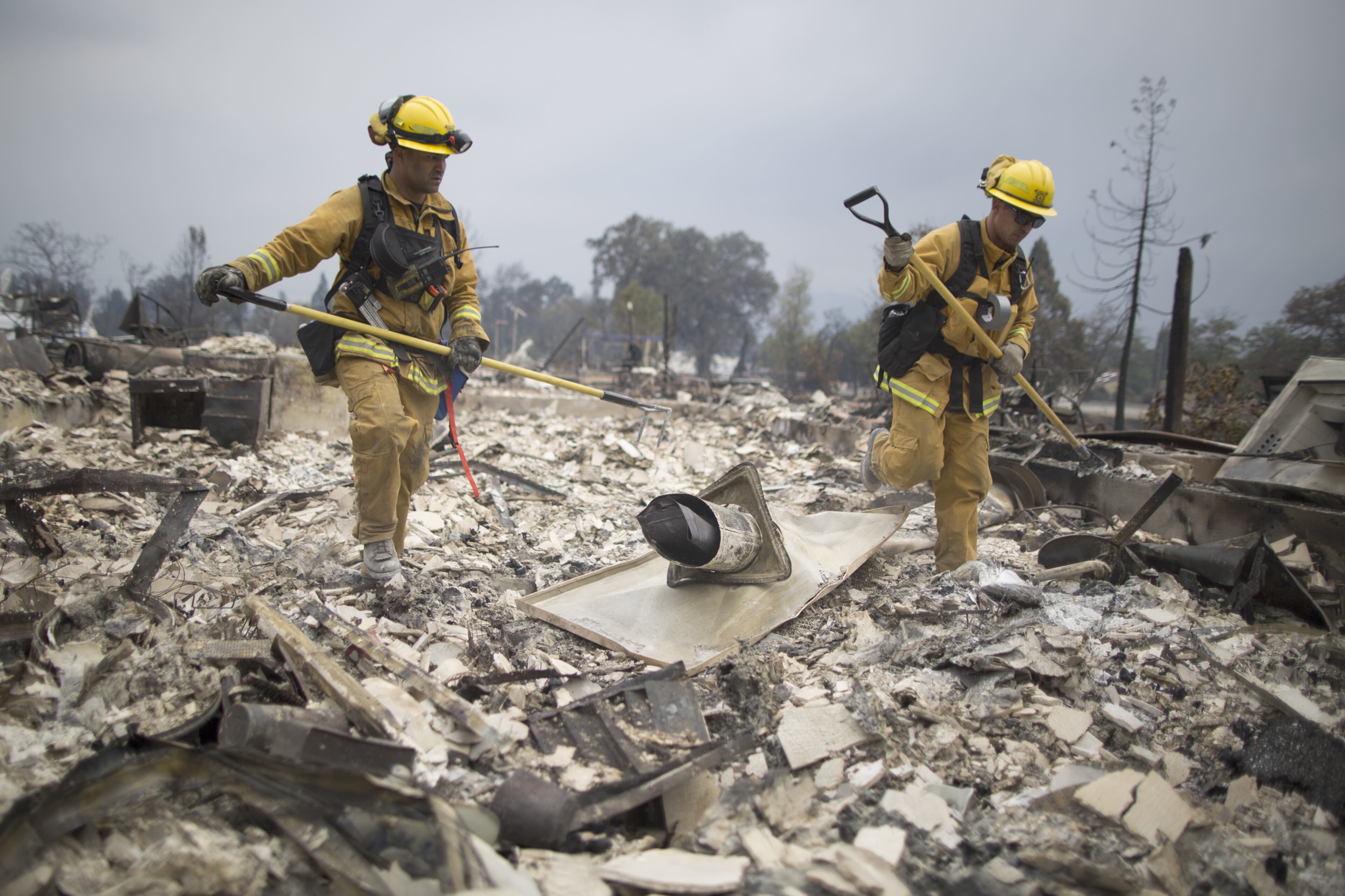 Firefighters look through the ruins of structures burned by the Valley Fire on September 14, 2015 in Middletown, California. The 95-square-mile fire has destroyed hundreds of homes and is only five percent contained. (Photo by David McNew/Getty Images)