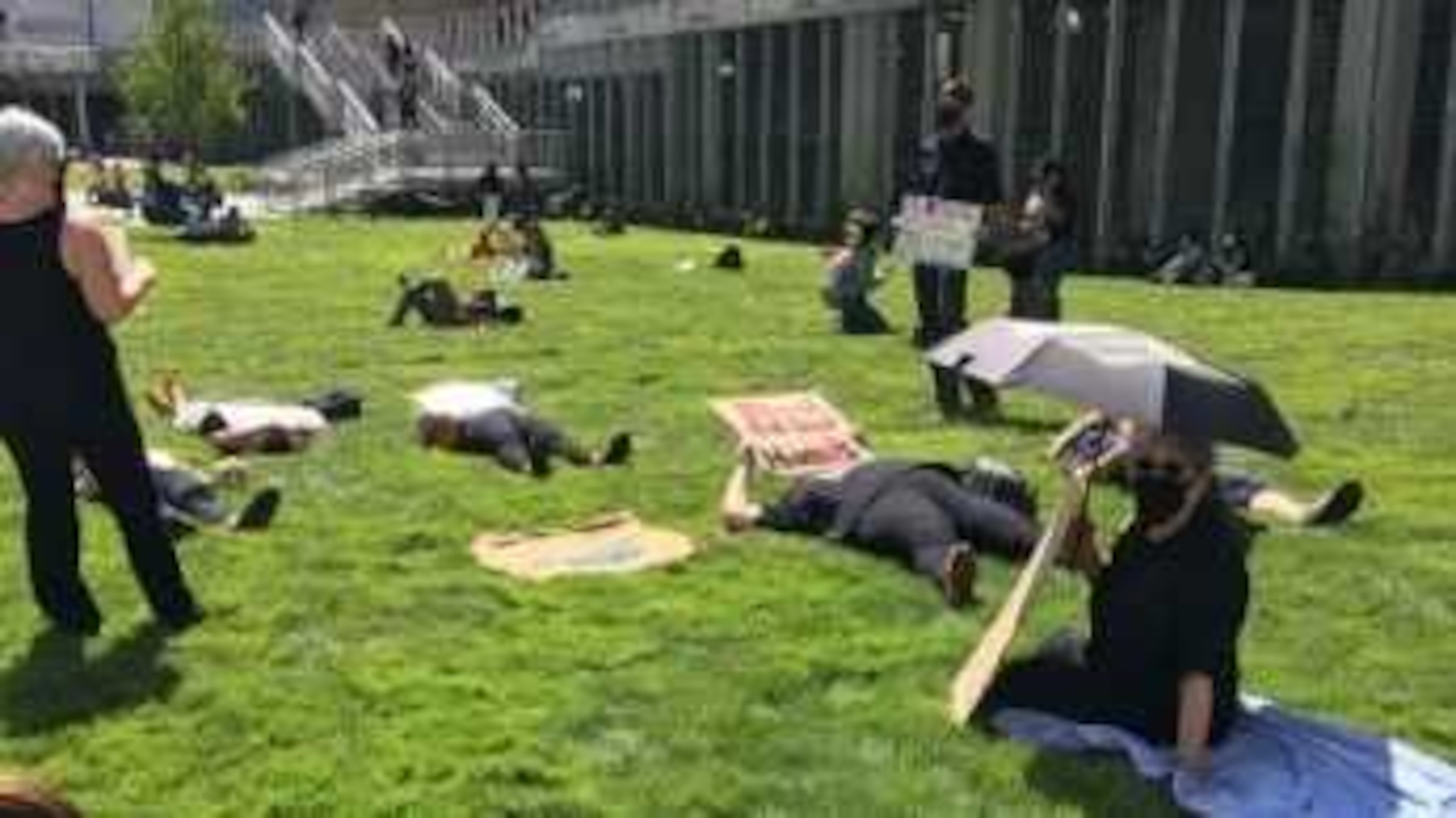 At least two dozen people gathered at Georgia State University's Atlanta campus on Sept. 9, 2021 for a "die-in" demonstration for additional safety measures to mitigate the spread of COVID-19 at the school. PHOTO CREDIT: United Campus Workers of Georgia.