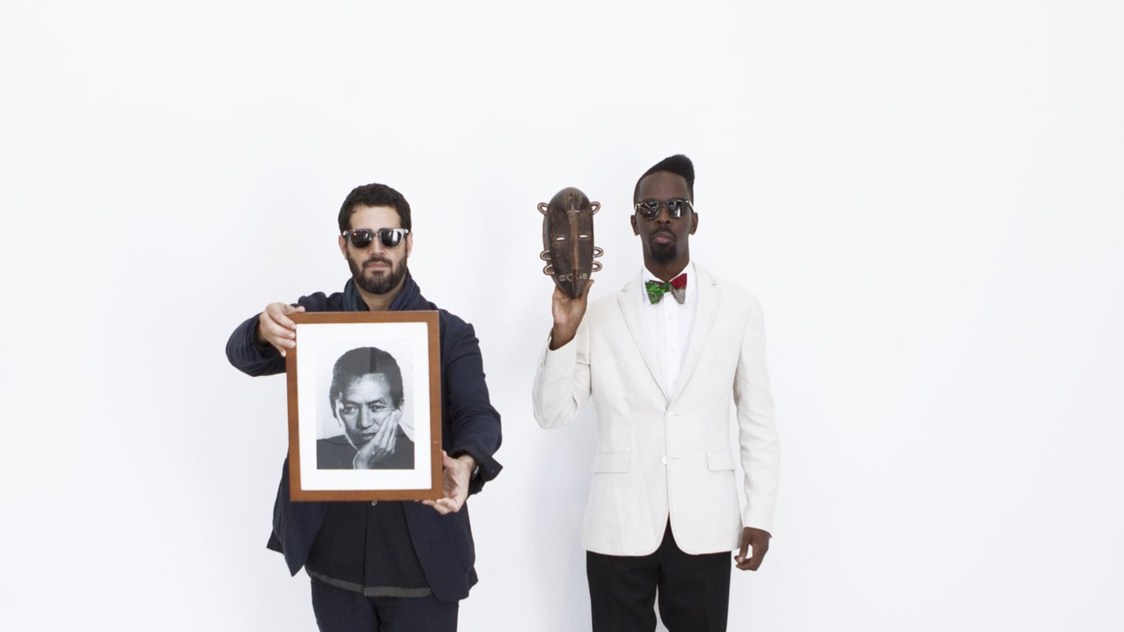 Jos Parl (left) and Fahamu Pecou (right). Parl is holding a portrait of Wifredo Lam by Man Ray. Brooklyn artist Parl and Atlantan Pecou have solo exhibits opening Feb. 14 at the High Museum that respond to the art of Cuban-born Surrealist Wilfredo Lam, the subject of a major High retrospective also opening Feb. 14.