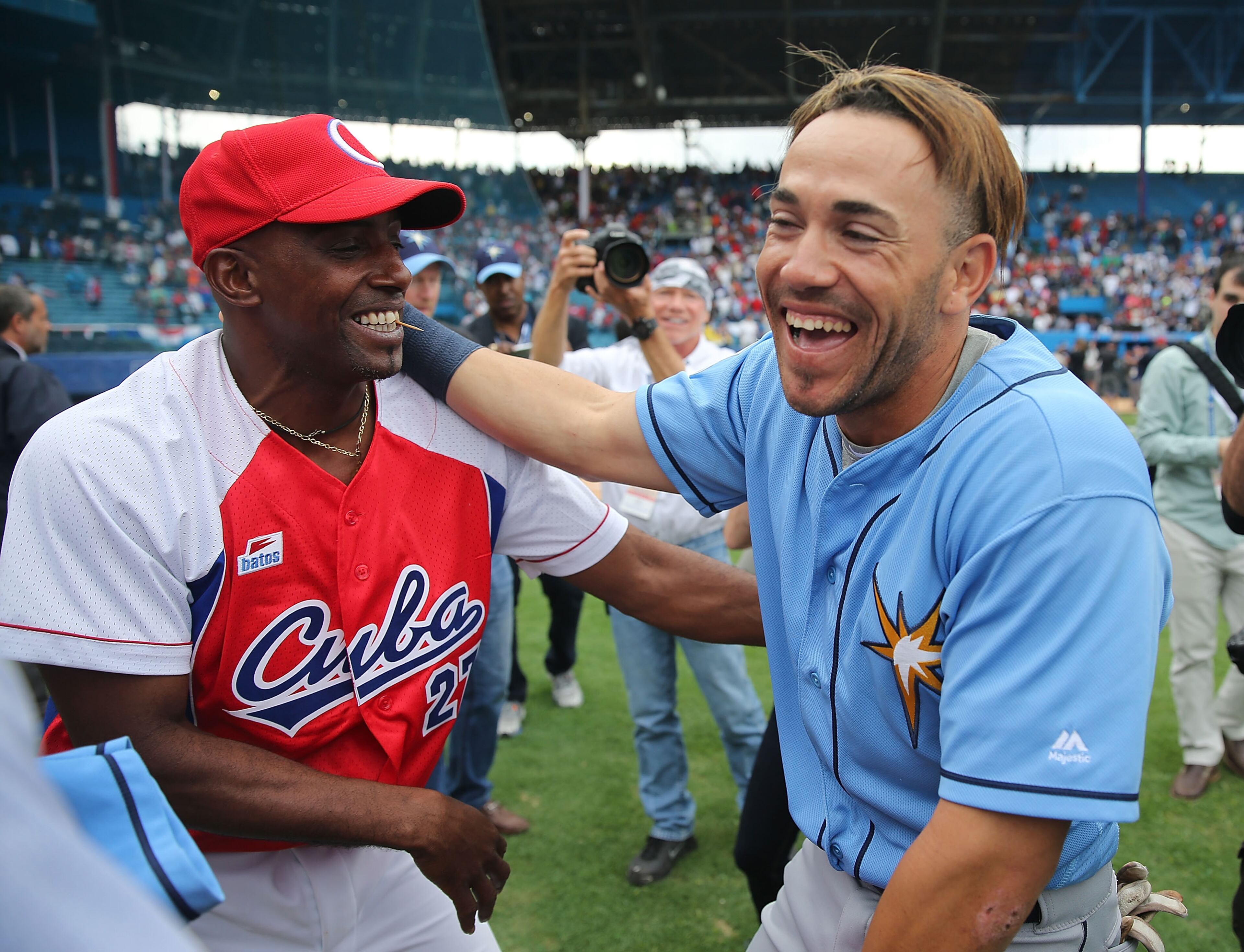 Tampa Bay Rays' Dayron Varona, who defected from Cuba in 2013, is hugged by members of the Cuban National team after the game at the Estado Latinoamericano March 22, 2016 in Havana, Cuba. (Photo by Joe Raedle/Getty Images)