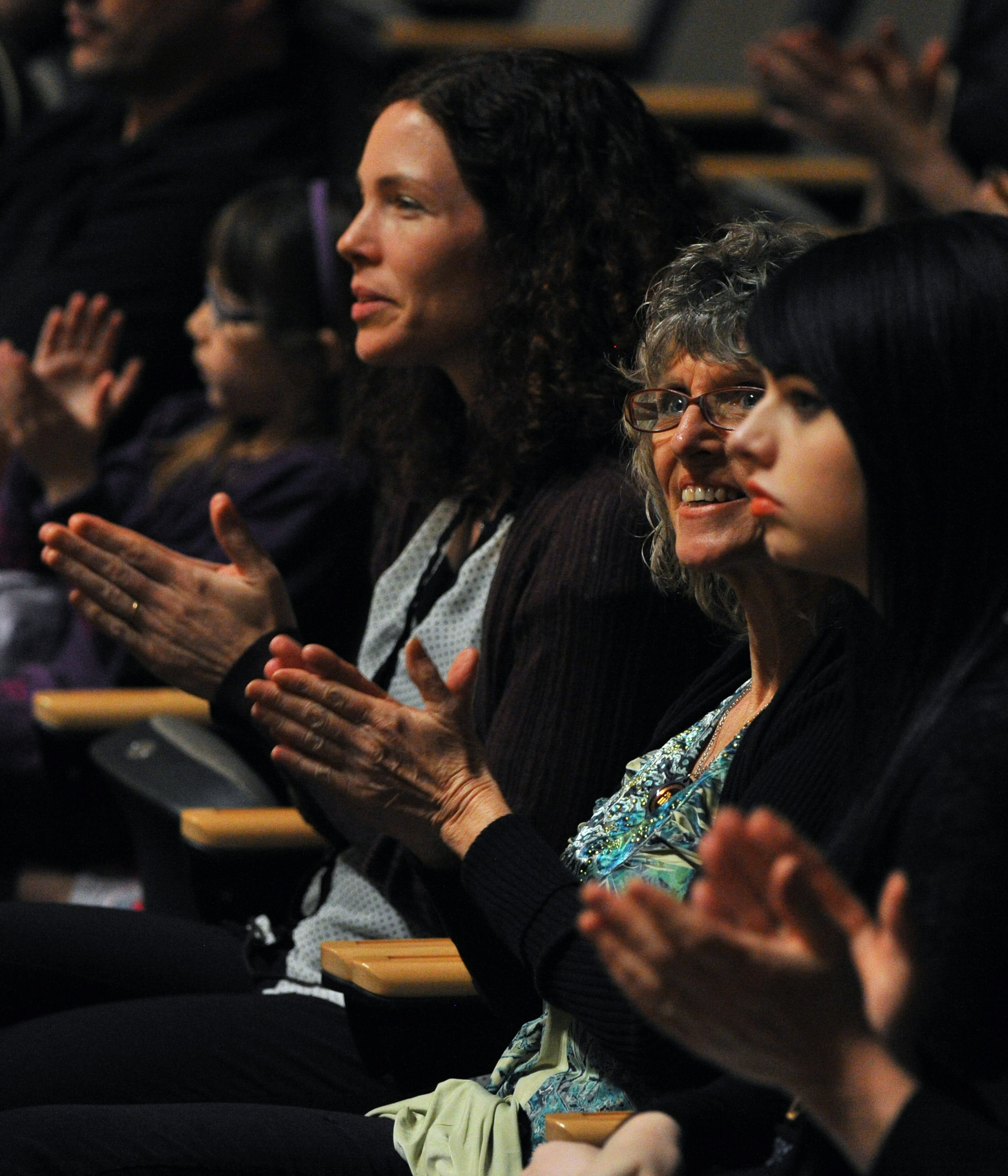 Maggi Pier, right center, the mother of drummer Jason Barnes, and Barnes' girlfriend, Amanda Dearborn, far right, clap during a Kennesaw State University concert on Saturday March 21, 2014 in Kennesaw, Ga. David Tulis / AJC Special