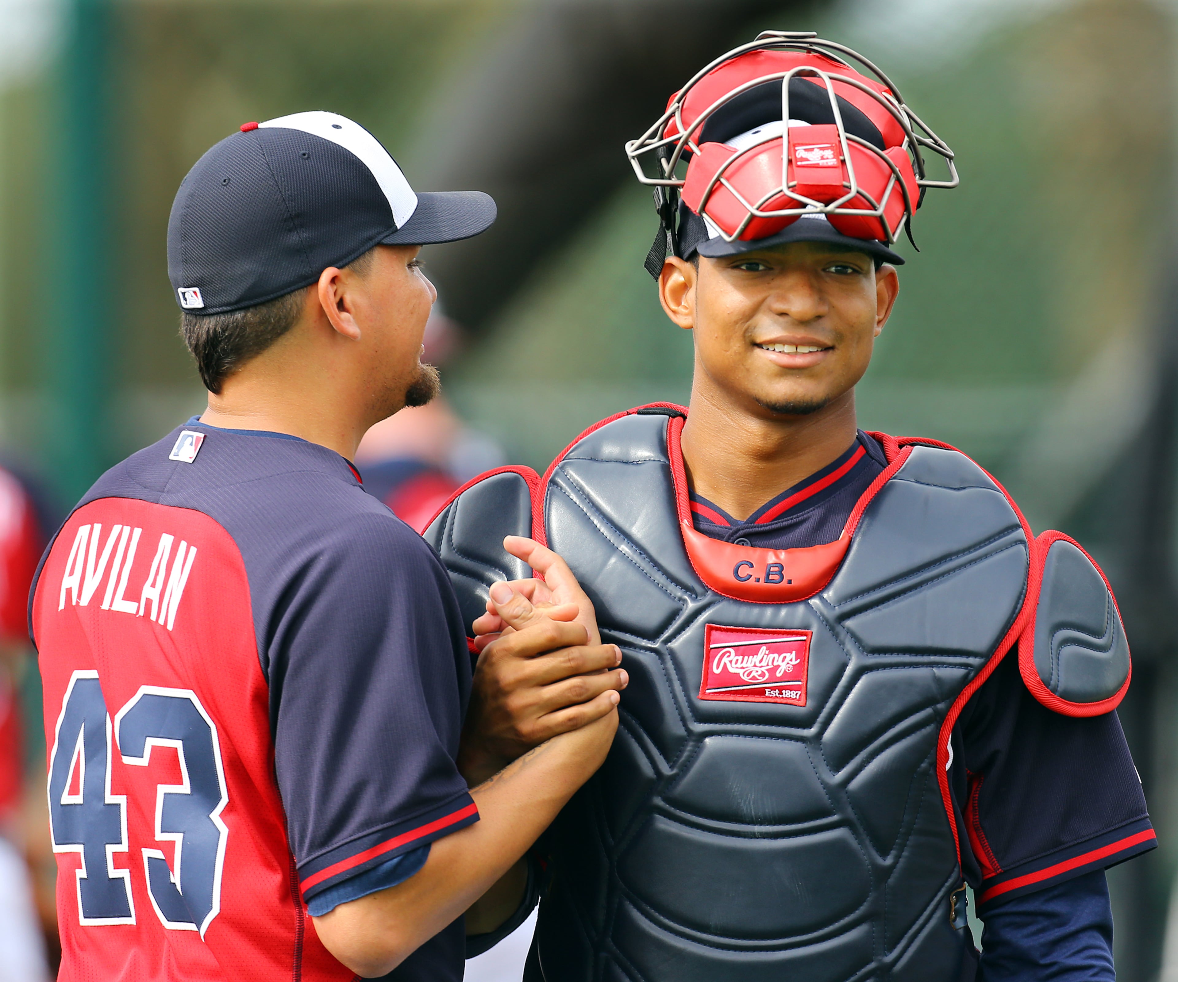 Braves catcher Christian Bethancourt and pitcher Luis Avilan clasp hands at the conclusion of catching drills during spring training on Friday, Feb. 21, 2014, in Lake Buena Vista, FL. CURTIS COMPTON / CCOMPTON@AJC.COM