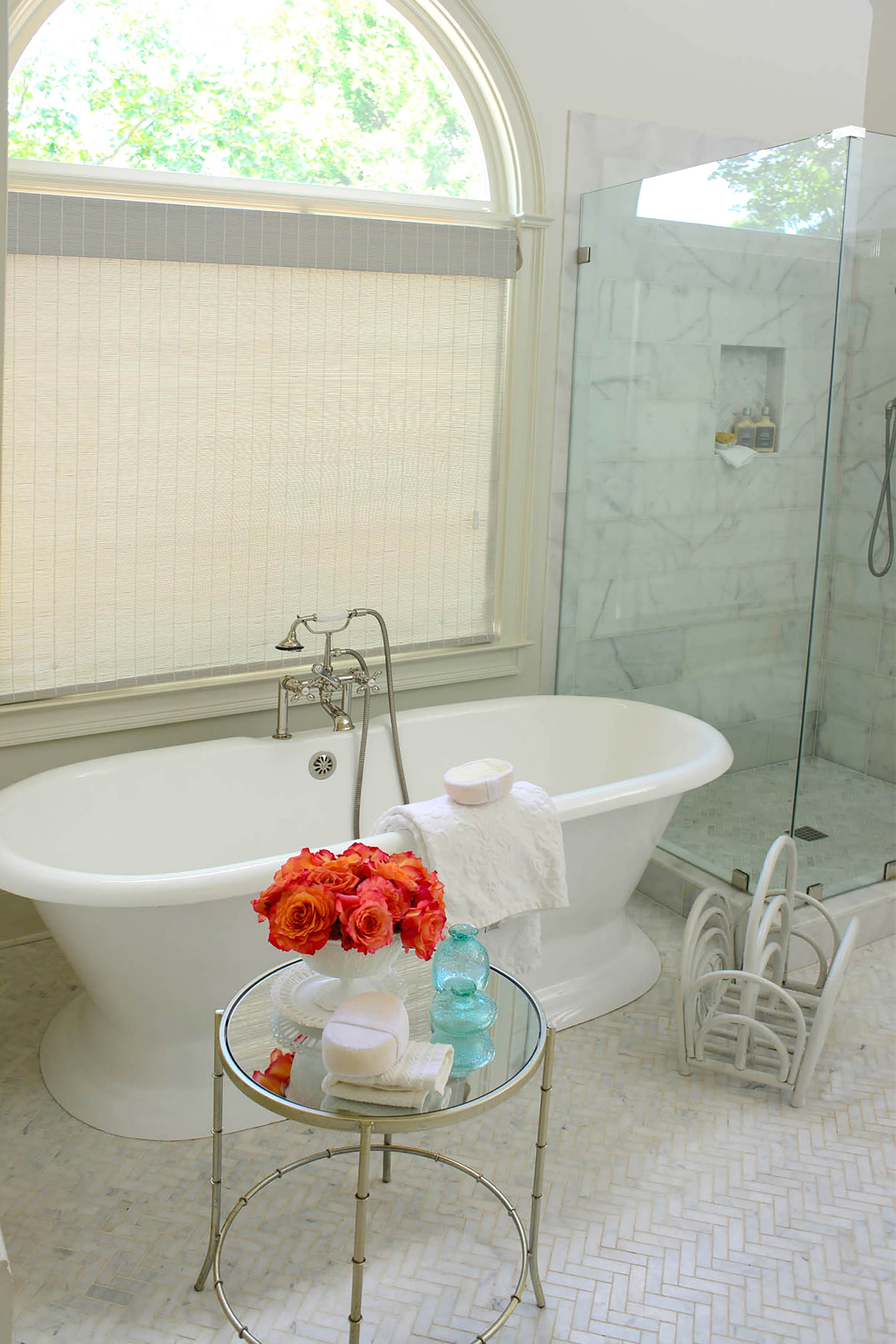 Edee's spa-like master bath includes a freestanding tub from Signature Hardware and marble herringbone floor tile from ProSource Wholesale. Modify Atlanta gutted and renovated the room last year.. Updates included nickel fixtures from Ferguson and a frameless shower.