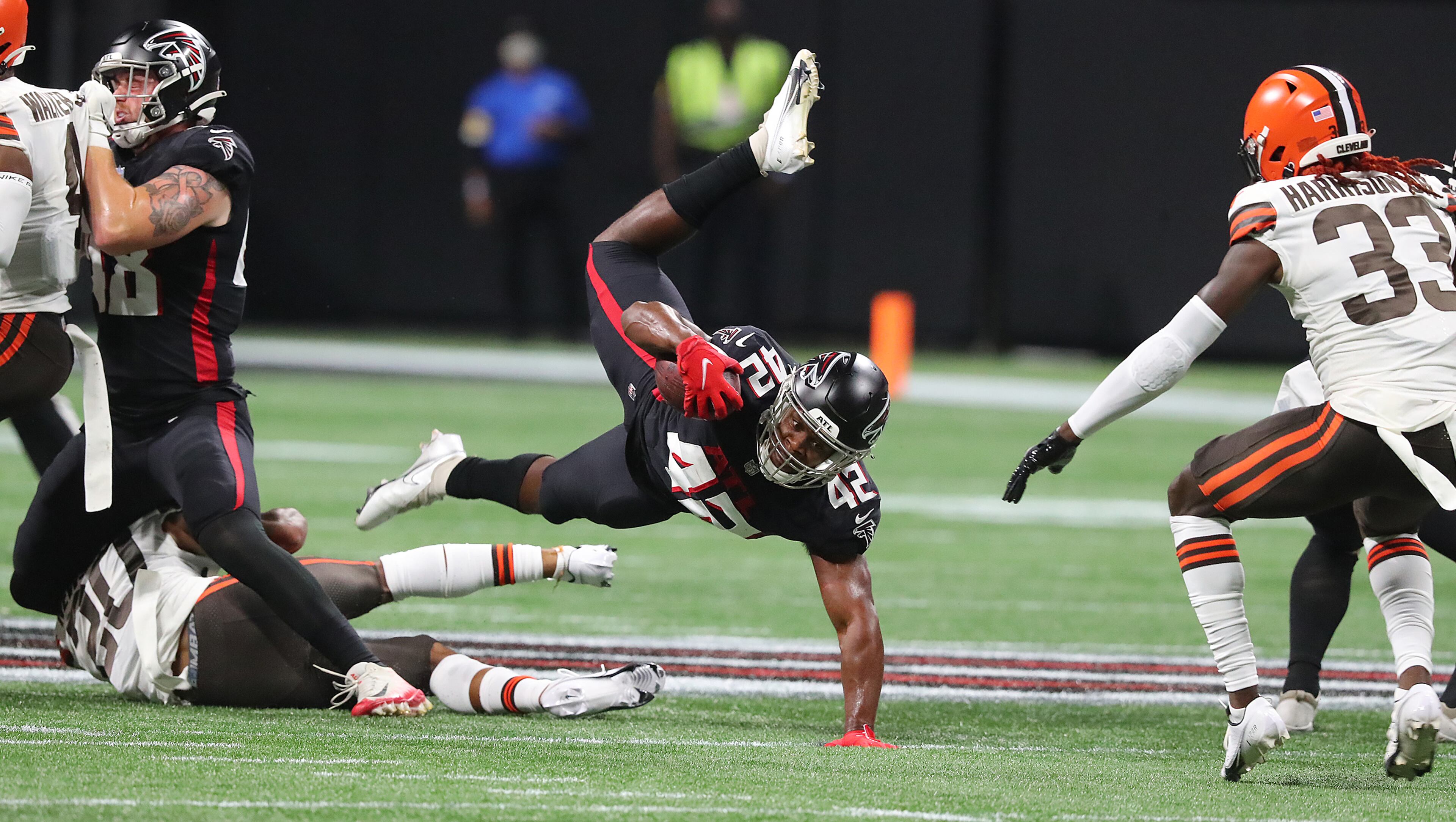 Falcons running back Caleb Huntley is upended by Cleveland Browns cornerback Greg Newsome II during the first half of exhibition game Sunday, Aug. 29, 2021, at Mercedes-Benz Stadium in Atlanta. (Curtis Compton / Curtis.Compton@ajc.com)