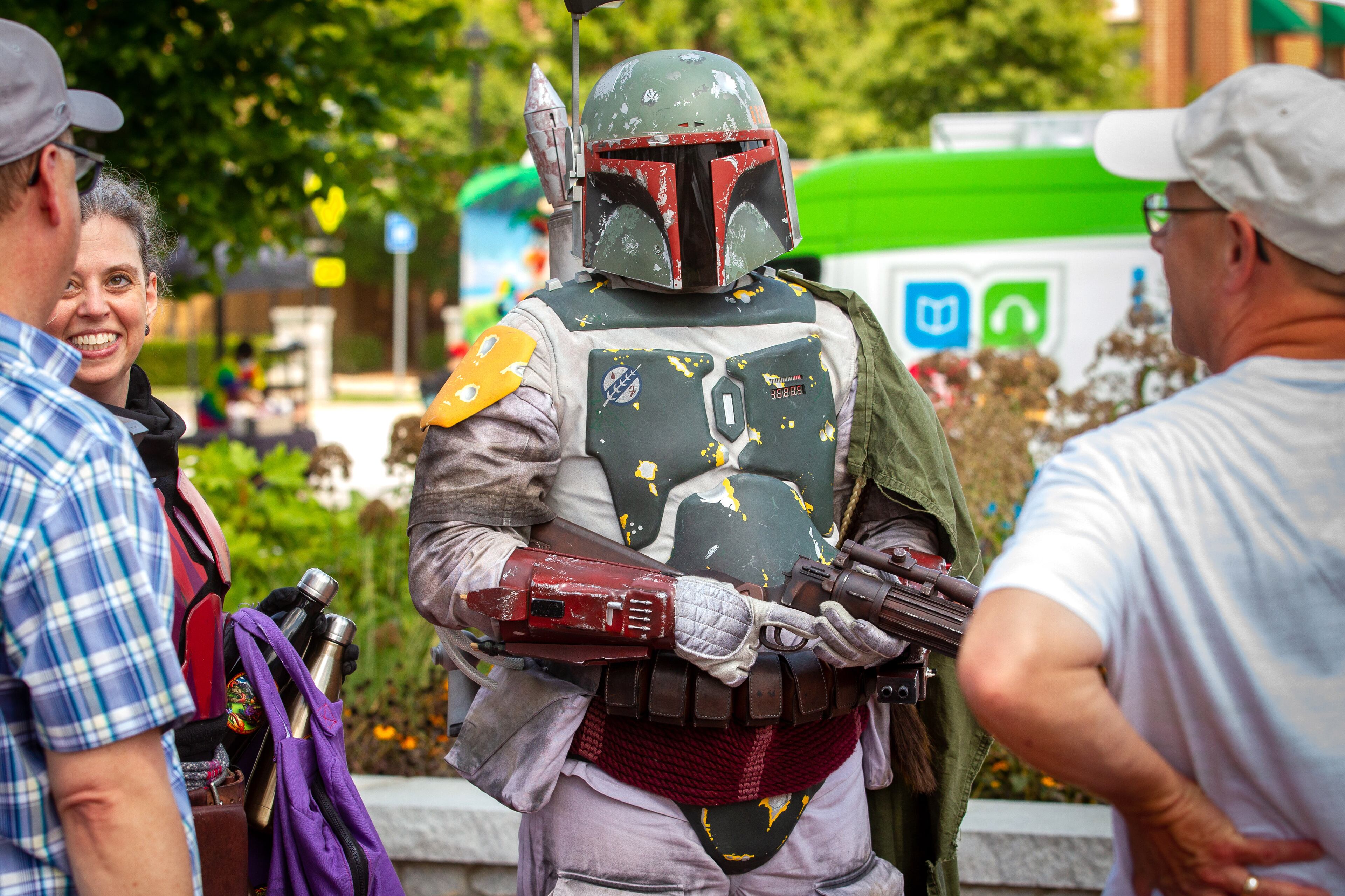 Cliff Bray, dressed as Boba Fett, talks with friends at the Lawrenceville Lawn park before the start of the Free Comic Book Day parade on Saturday, August 14, 2021. STEVE SCHAEFER FOR THE ATLANTA JOURNAL-CONSTITUTION
