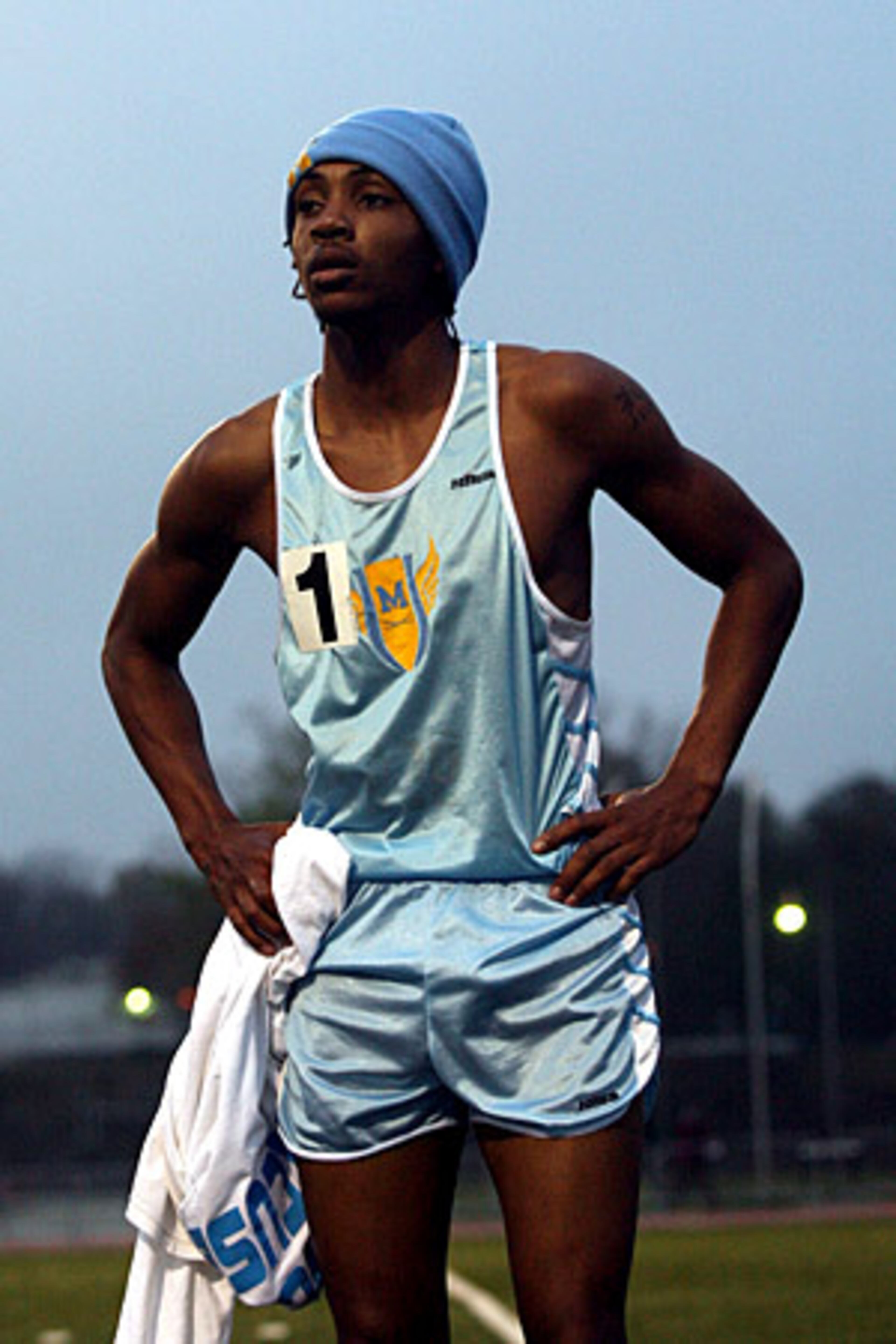 After placing first in the Boys' 3200 Meters, Walston takes a breather while watching the remaining runners finish.