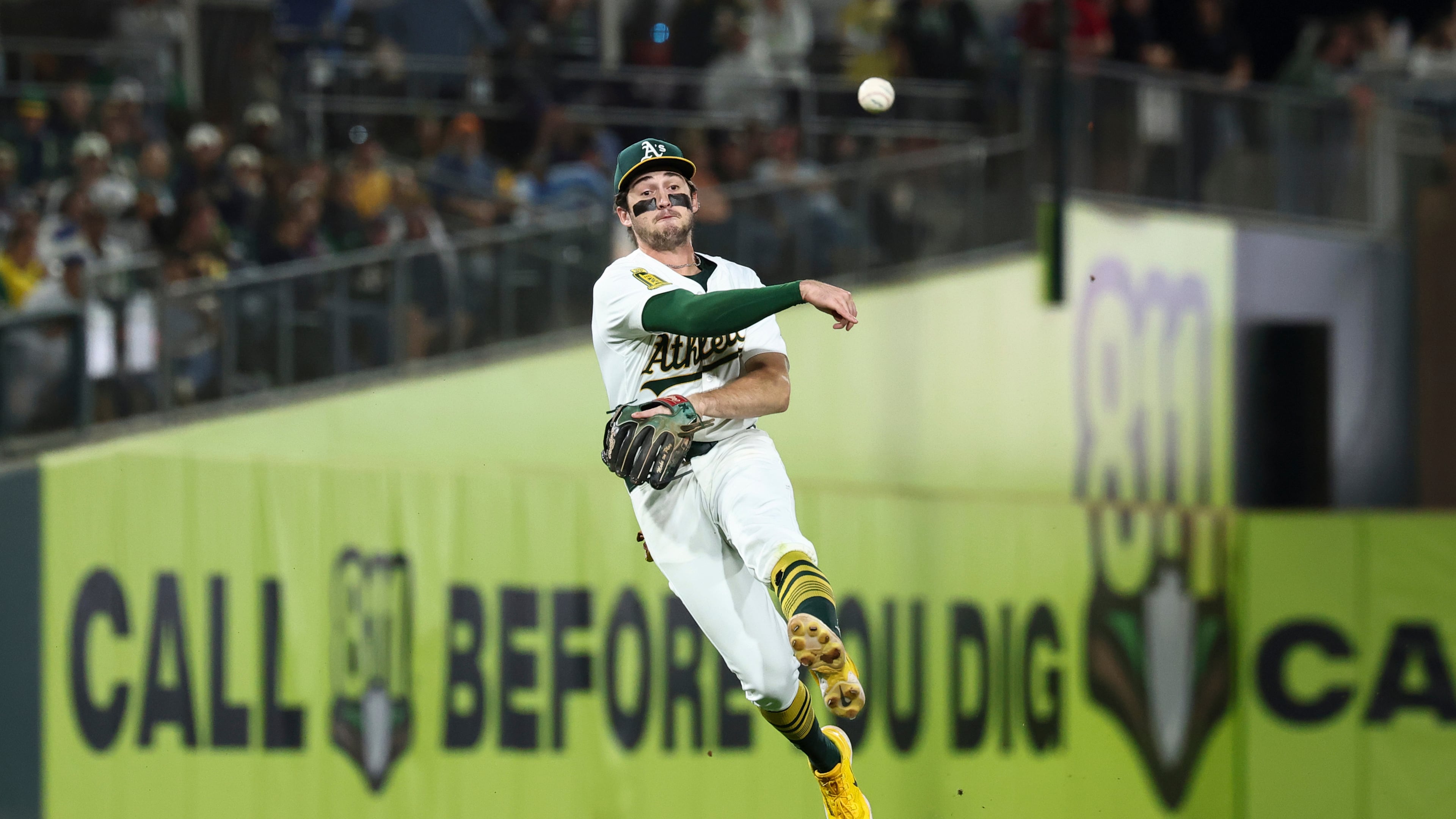 FILE - Athletics shortstop Jacob Wilson throws to first base during the seventh inning of a baseball game against the Kansas City Royals in West Sacramento, Calif., Sept. 27, 2025. (AP Photo/Sara Nevis, File)