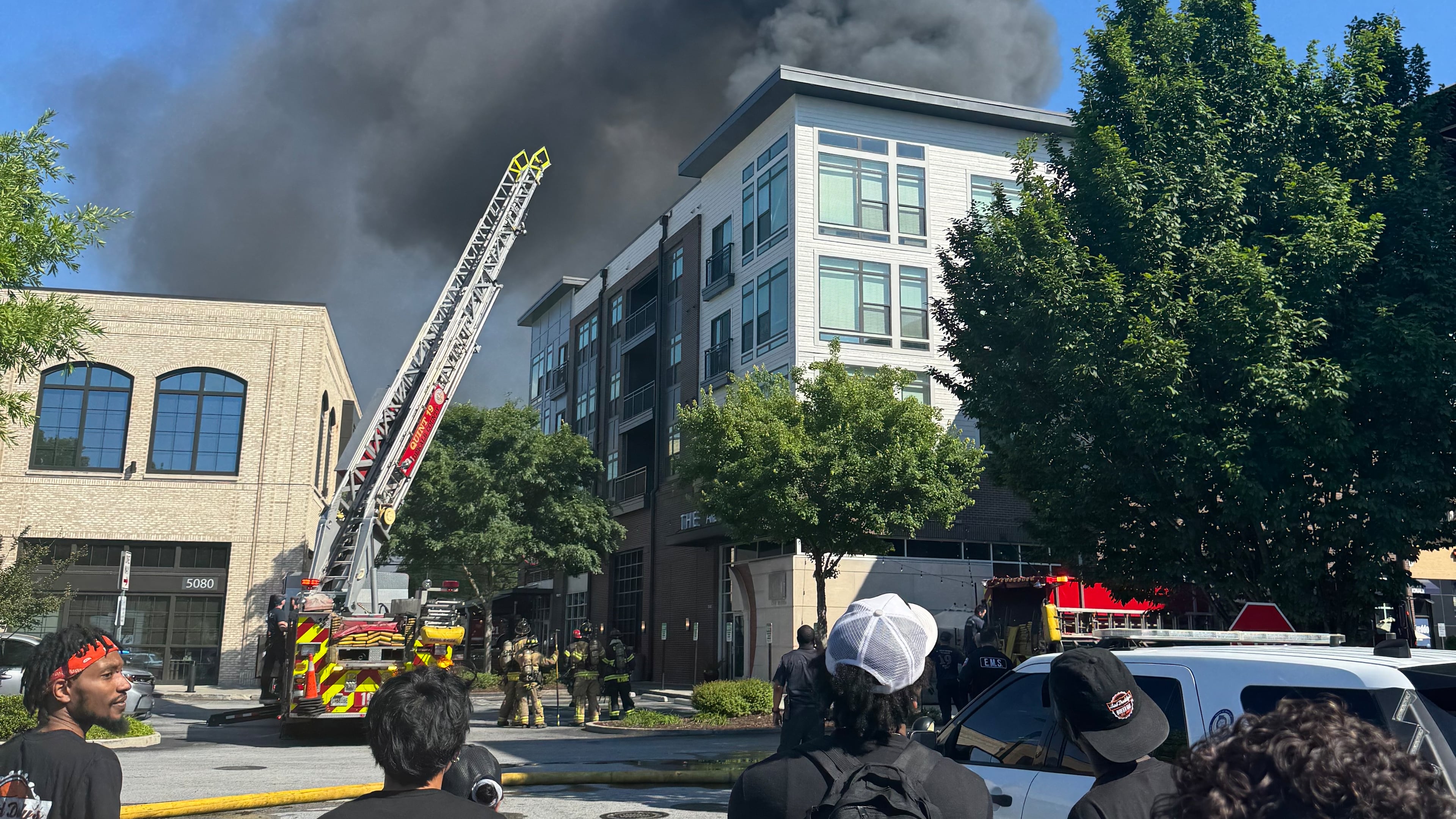 Onlookers watch the Parkview on Peachtree Boulevard apartment complex burn. The fire caused smoke and water damage to the Alden restaurant.(Courtesy of Jared Hucks)