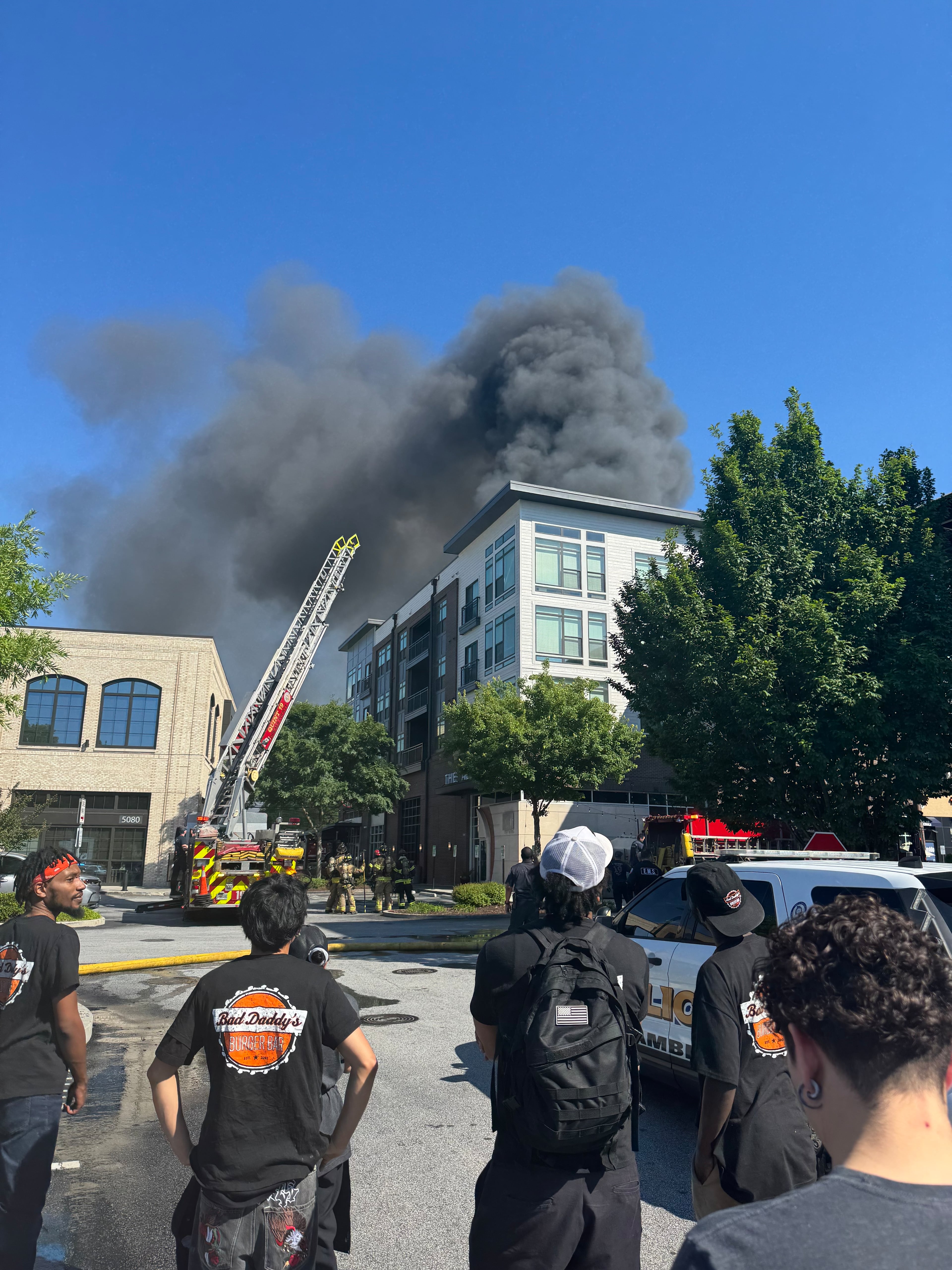 Onlookers watch the Parkview on Peachtree Boulevard apartment complex burn. (Courtesy of Jared Hucks/The Alden)