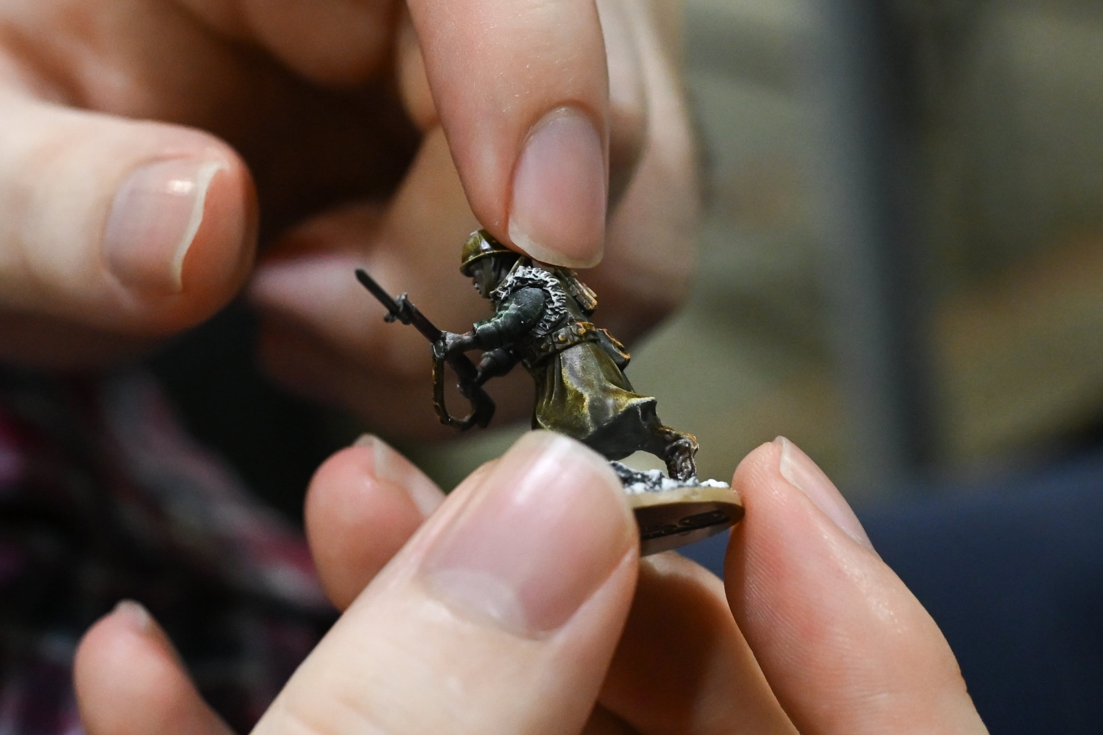 Austin Cox shows a handpainted miniature during MomoCon at the Georgia World Congress Center in Atlanta on Friday, May 22, 2026. (Tyler Sun for the AJC)