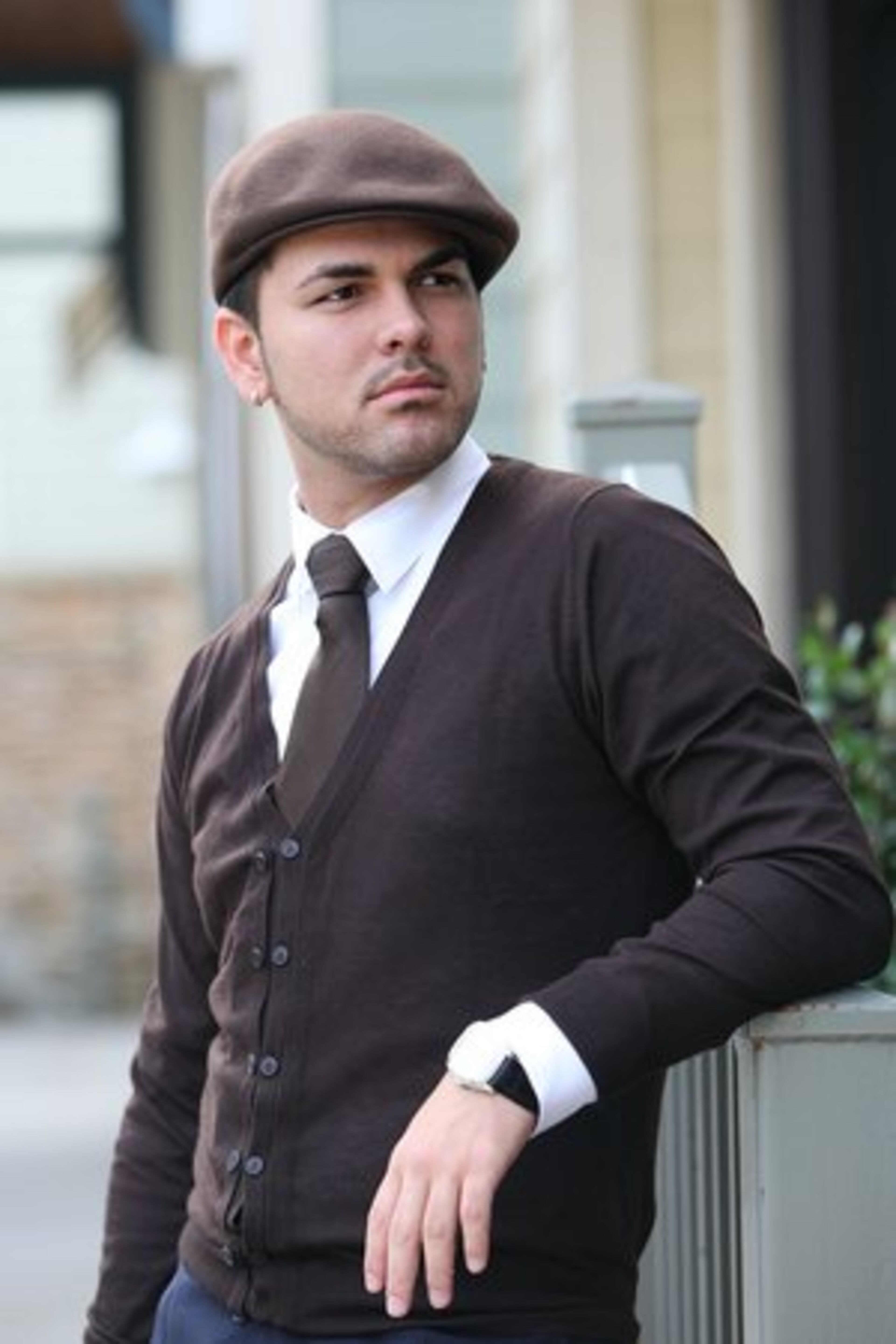 FAVORITE STORES: Neiman Marcus, David Yurman, Bulgari and Louis Vuitton. Brown cardigan and silk tie by Zara, slim-cut Hugo Boss dress shirt and newsboy cap by Zara.