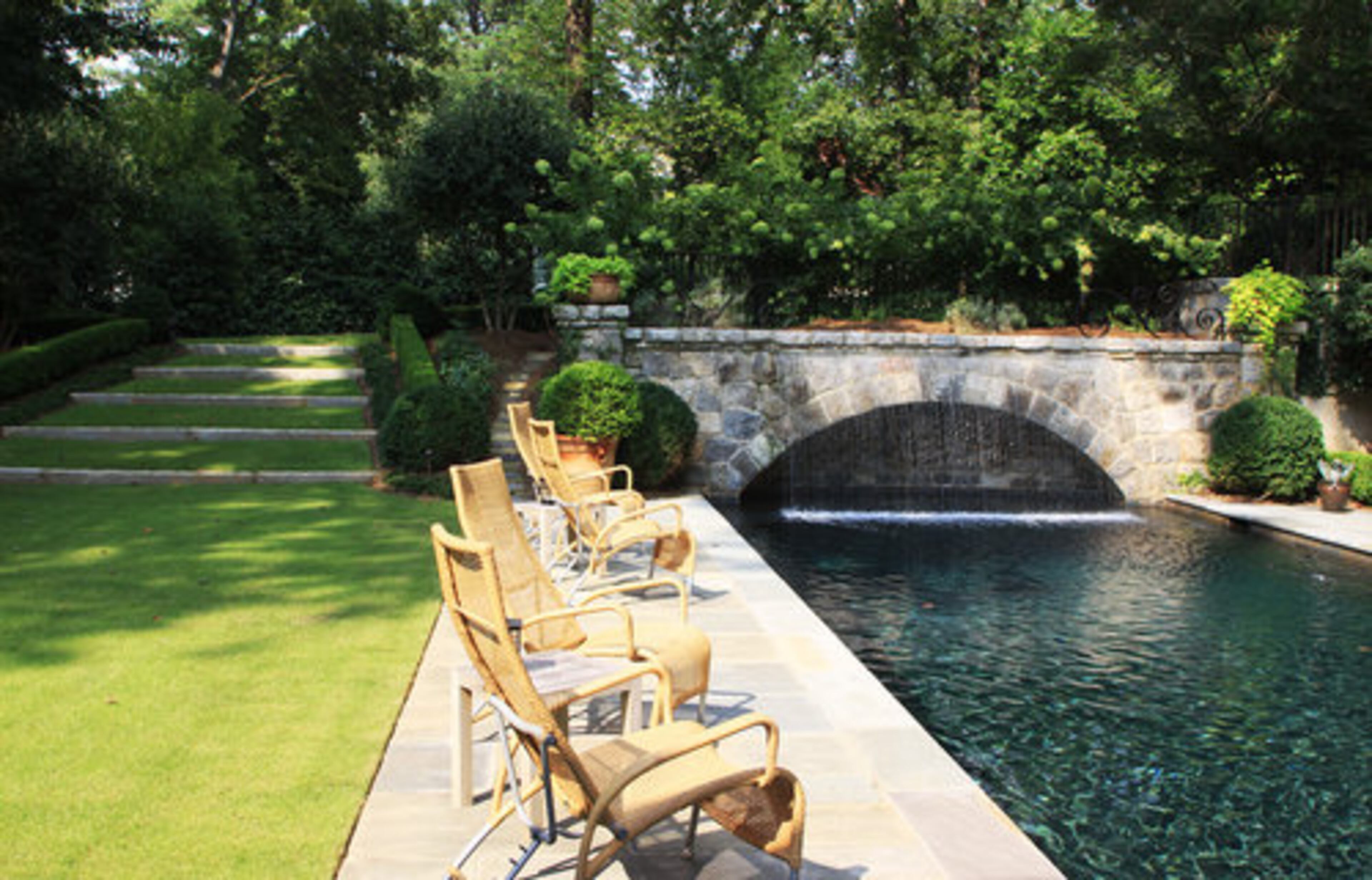 Landscape architect Richard Anderson honored the Salisbury's wishes to save as many of the original plants as possible. He had white hydrangeas and azaleas transplanted during construction, then returned once the house was finished. They and snowball viburnum, English boxwood, native fern, cedar and creeping fig are prominent in the design.