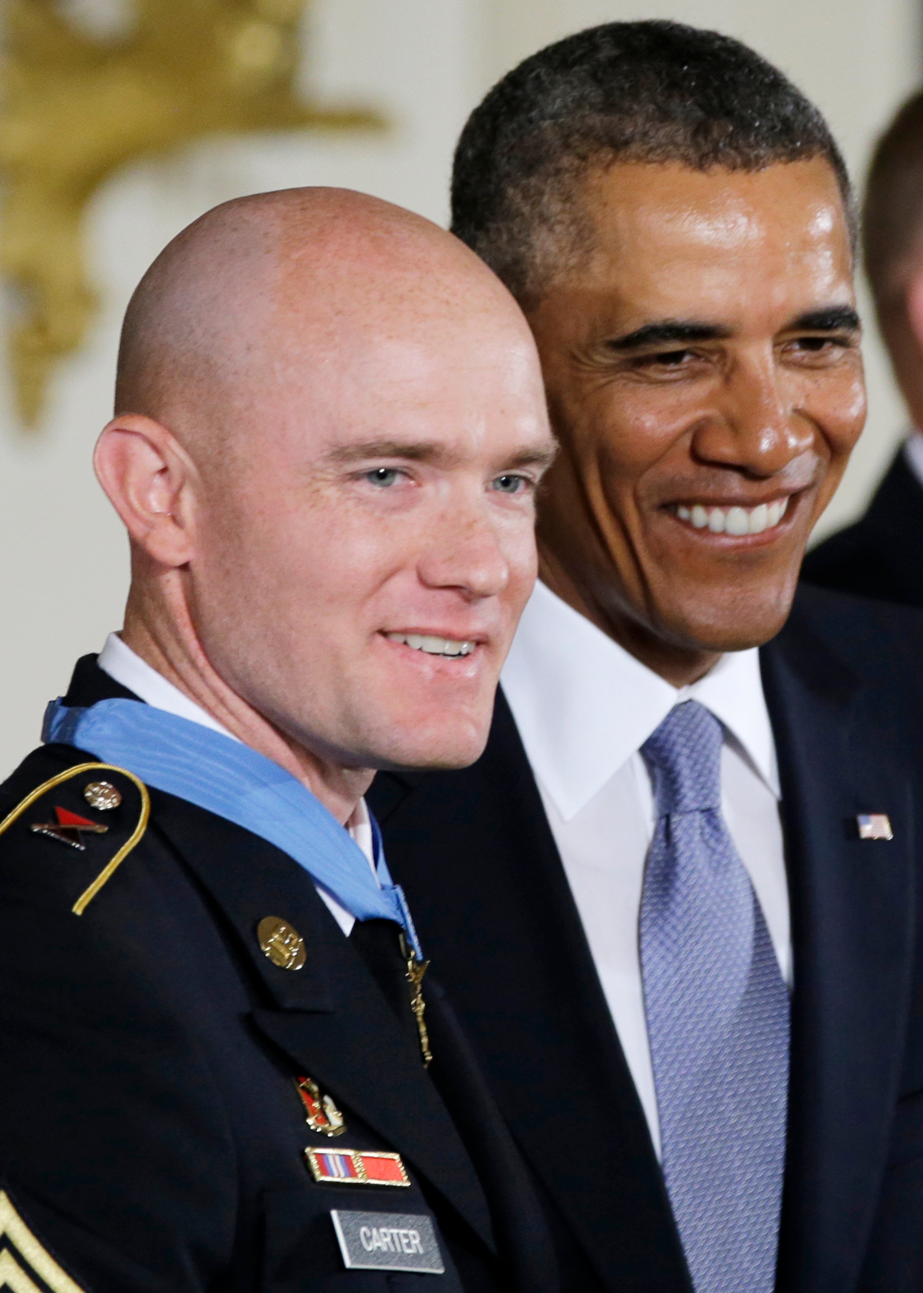 President Barack Obama stands with US Army Staff Sgt. Ty M. Carter after awarding him the Medal of Honor for conspicuous gallantry, Monday, Aug. 26, 2013, during a ceremony in the East Room of the White House in Washington. Carter received the medal for his courageous actions while serving as a cavalry scout with Bravo Troop, 3rd Squadron, 61st Cavalry Regiment, 4th Brigade Combat Team, 4th Infantry Division, during combat operations in Kamdesh District, Nuristan Province, Afghanistan on Oct. 3, 2009. Carter is the fifth living recipient to be awarded the Medal of Honor for actions in Iraq or Afghanistan. (AP Photo/Carolyn Kaster)