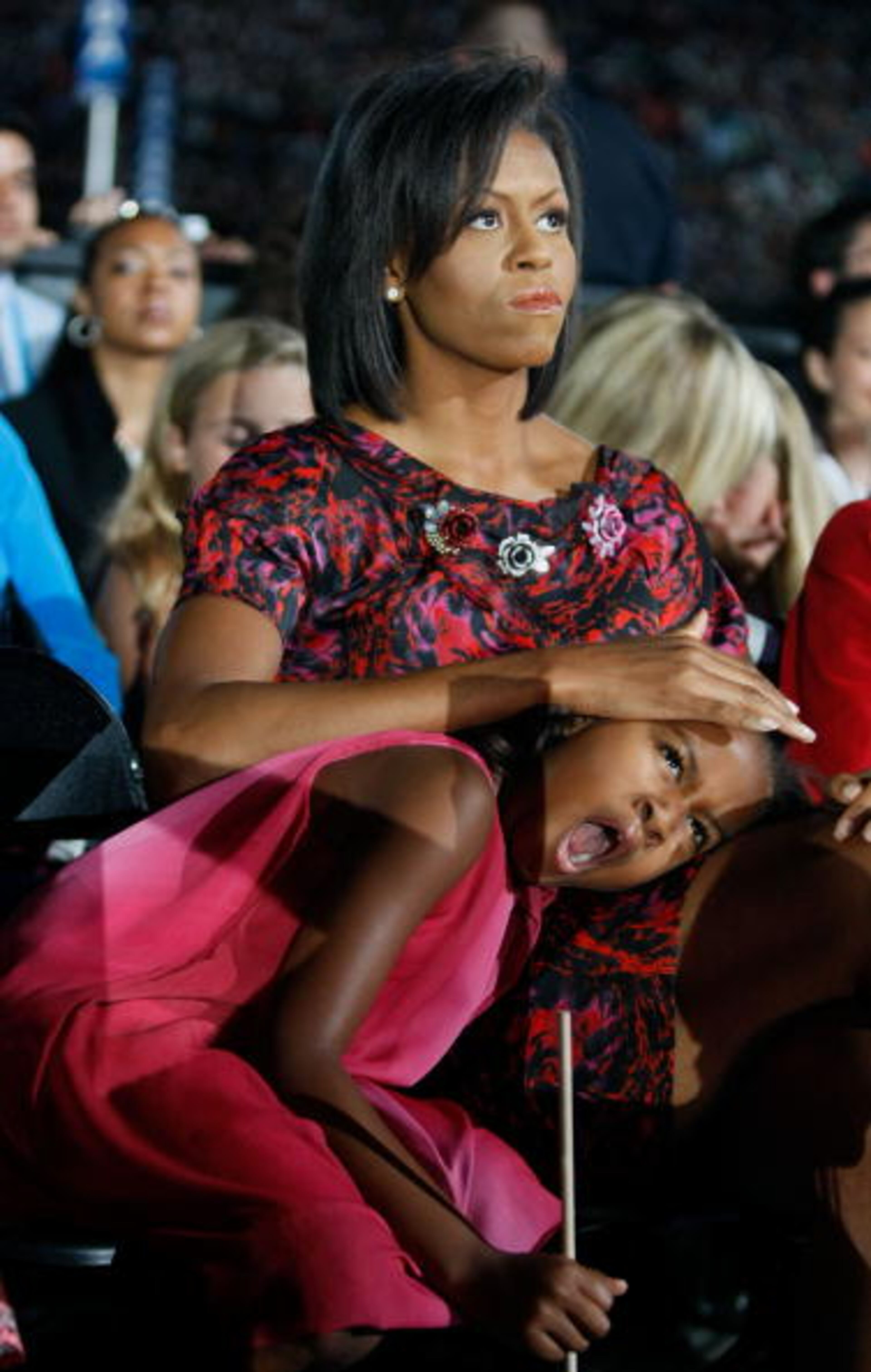 DENVER - AUGUST 28 Sasha Obama yawns during her father Barack Obama's speech as Michelle Obama holds her head on day four of the Democratic National Convention (DNC) at Invesco Field at Mile High August 28, 2008 in Denver, Colorado. U.S. Sen. Barack Obama (D-IL) is the first African-American to be officially nominated as a candidate for U.S. president by a major party. (Photo by Joe Raedle/Getty Images)