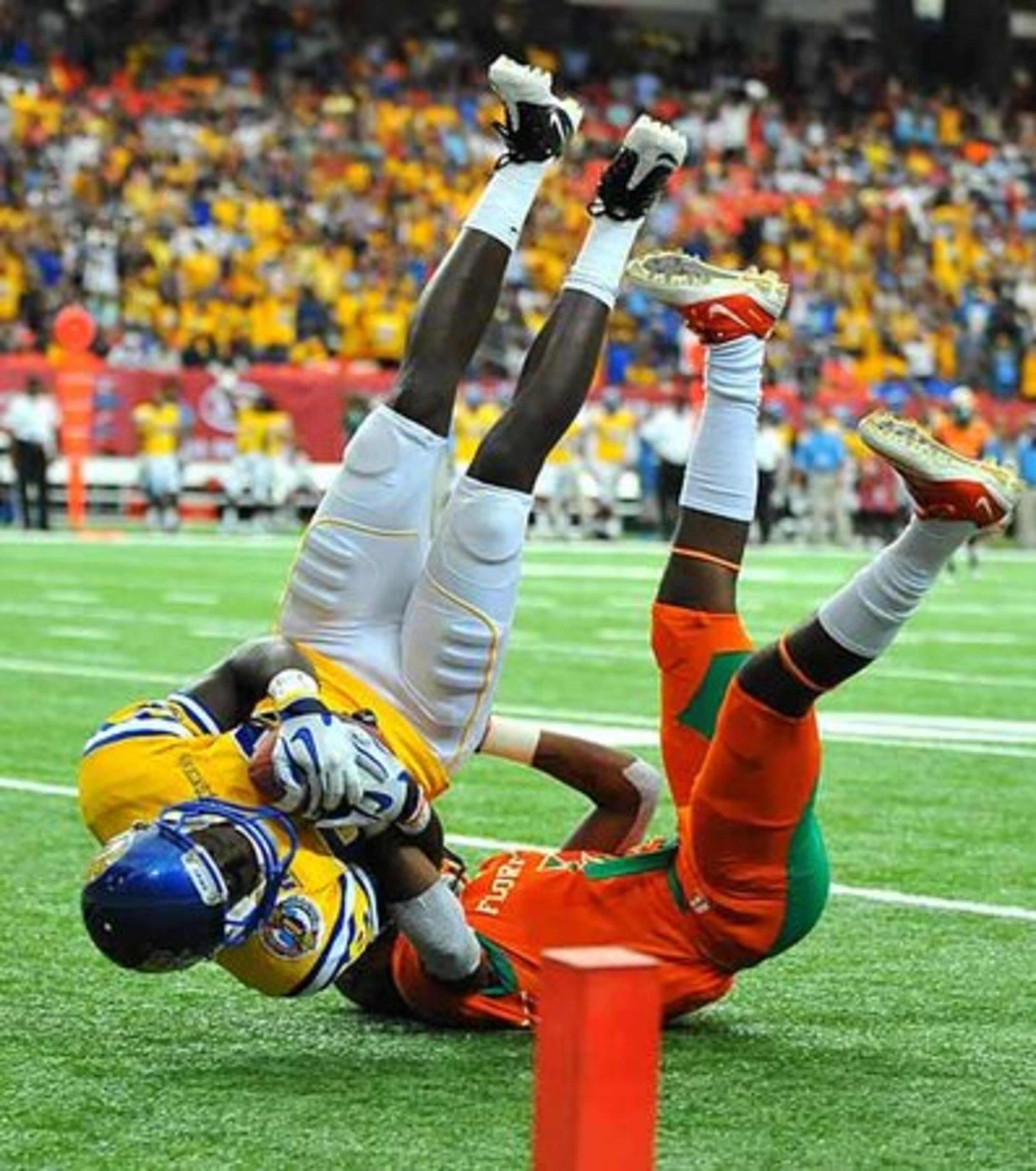 Southern University receiver LaQuinton Evans, left, is upended by Florida A&M University defender Devonate Johnson after making a catch on the one-yard line.