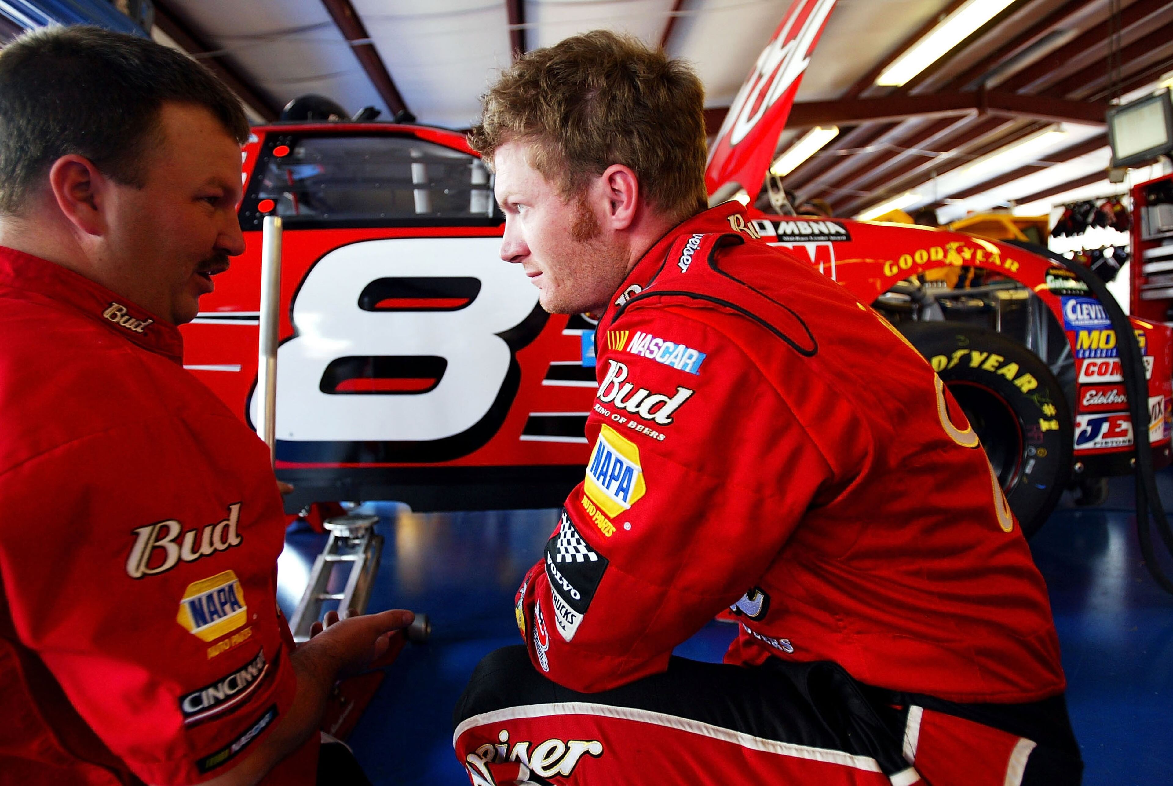 TALLADEGA, AL - APRIL 23: Dale Earnhardt Jr., driver of the #8 Budweiser Chevrolet, talks with a mechanic in the garage during practice for the Aaron's 499 on April 23, 2004 at Talladega SuperSpeedway in Talladega, Alabama. (Photo by Jamie Squire/Getty Images)
