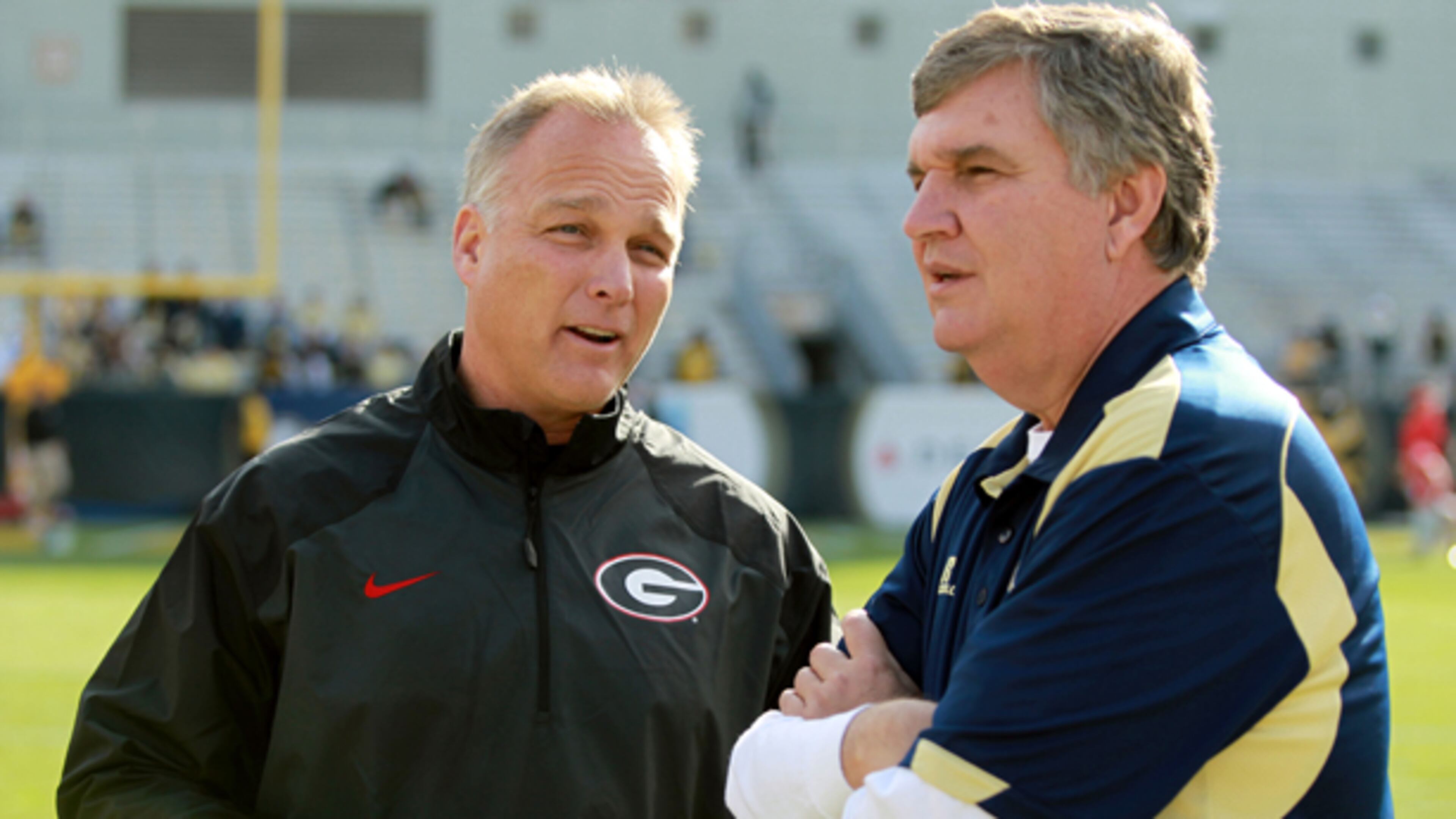 November 30, 2013 - Atlanta, Ga.: University of Georgia coach Mark Richt, left, talks with Georgia Tech coach Paul Johnson before their game at Bobby Dodd Stadium Saturday afternoon in Atlanta, Ga., November 30, 2013. JASON GETZ / JGETZ@AJC.COM Mark Richt and Paul Johnson both had big wins, bad losses. (Jason Getz, AJC)