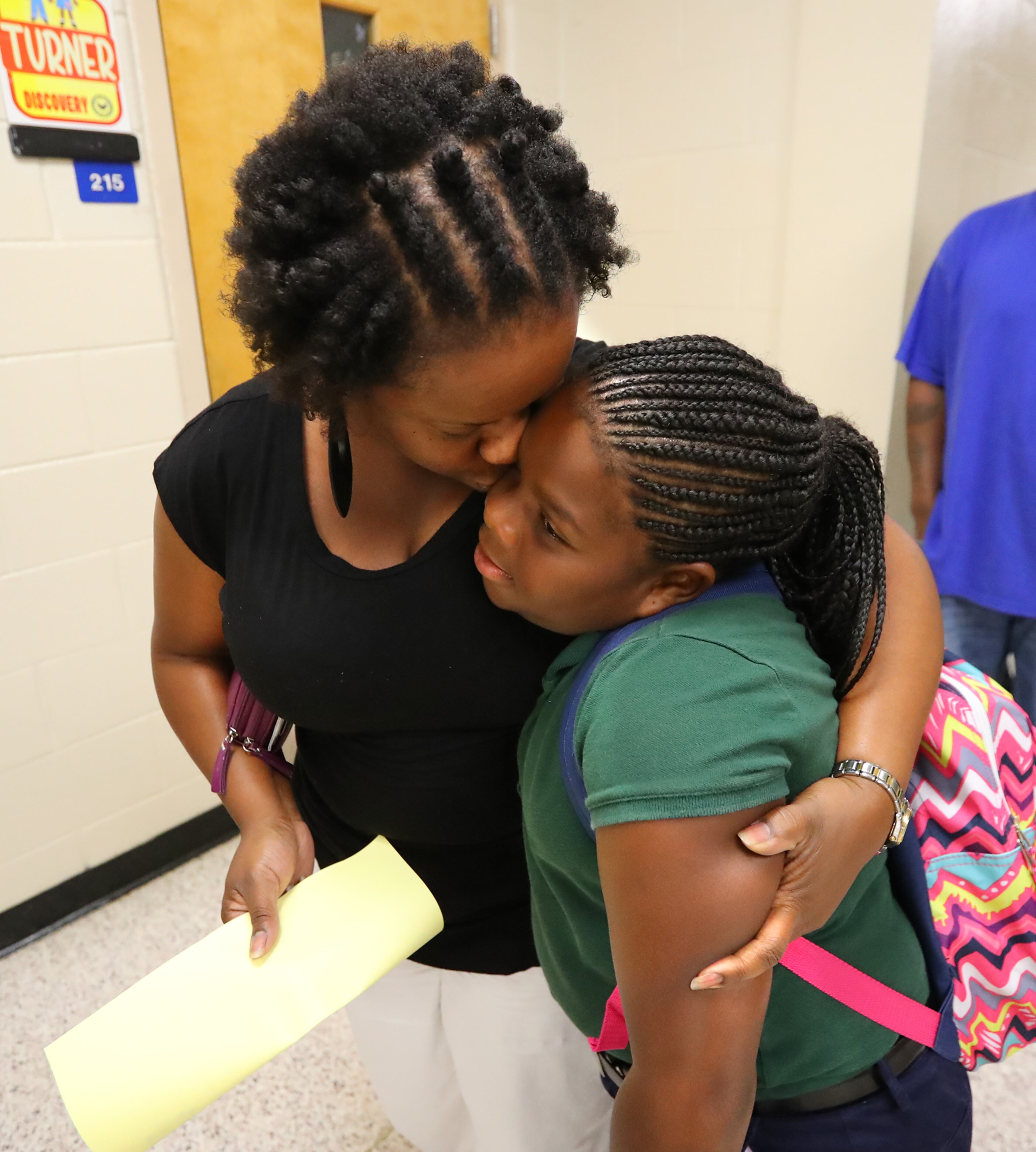 August 7, 2017 Lithonia; Latonya Davis gives her daughter Nailah Ruffin, 10, a hug goodbye at her fifth grade classroom on the first day of school at Edward L Bouie Elementary School on Monday, August 7, 2017, in Lithonia. Curtis Compton/ccompton@ajc.com