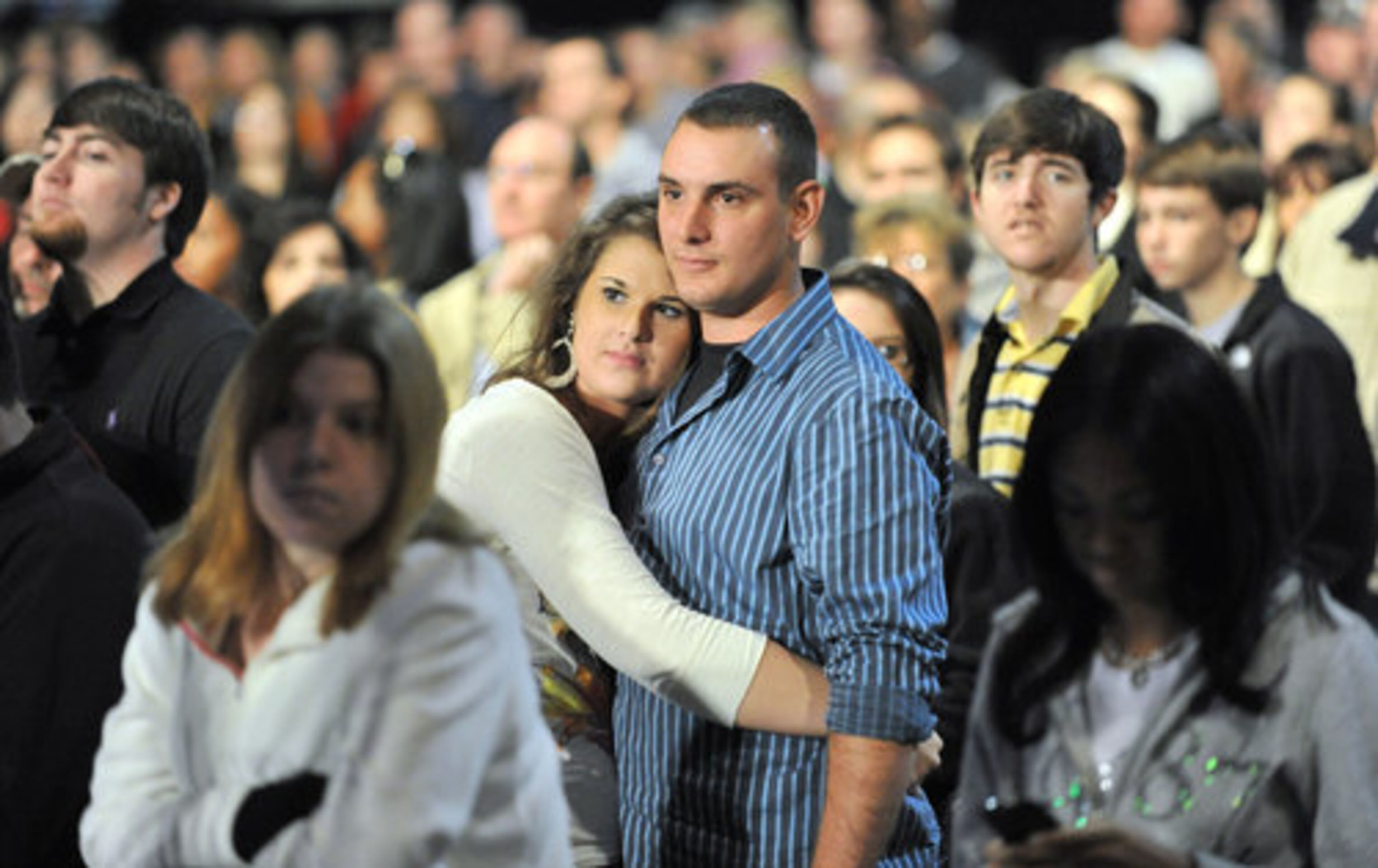 Crystal Bryan (center left) and her boyfriend David Materese, both of Newnan, listen to live performance during the 63rd annual Macy's Great Tree Lighting Show at Lenox Square Mall on Thursday, Nov. 25, 2010. For more than six decades, generations of Atlantans have welcomed the holiday season with the lighting of the Macy s Great Tree.