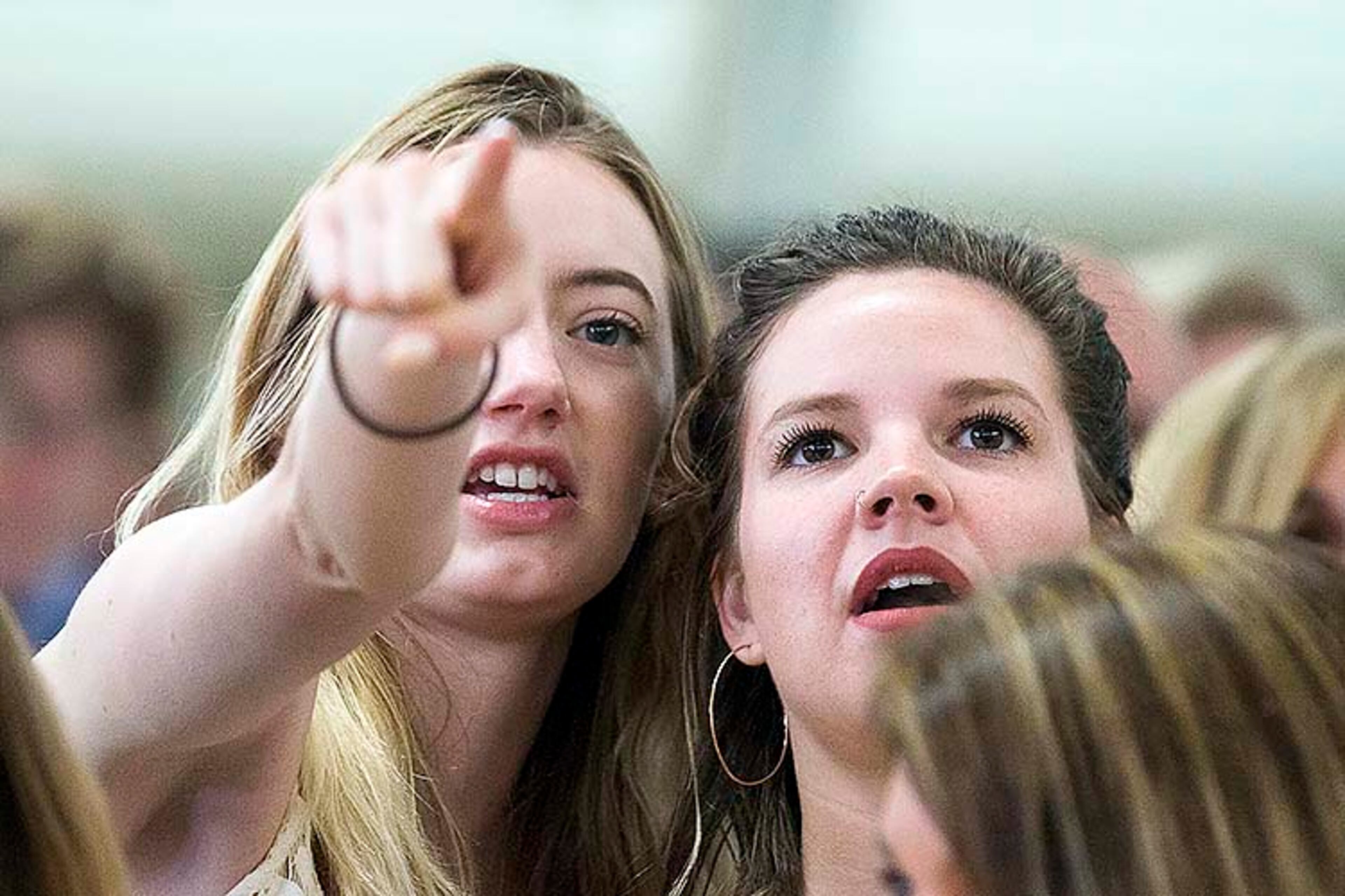 05/09/2019 -- Kennesaw, Georgia -- Charlotte Hinton (left) and Alyssa Egelhoff (right0) look for their friend Shannon Murphy during the 223rd Kennesaw State University commencement ceremony on the convocation center at the university's main campus in Kennesaw, Thursday, May 9, 2019. (ALYSSA POINTER/ALYSSA.POINTER@AJC.COM)