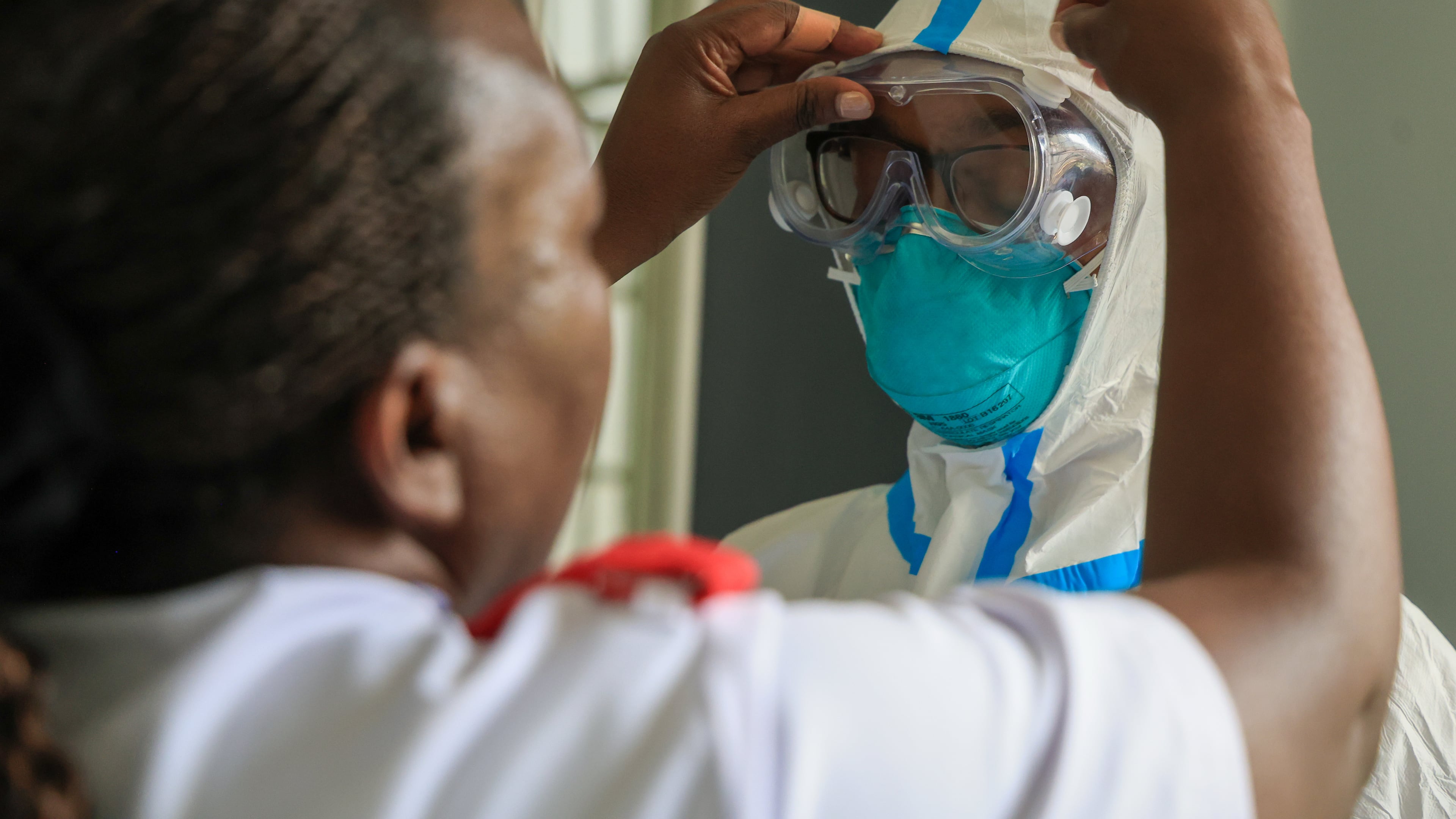 A health worker helps a colleague to put on a Personal Protective Equipment (PPE) in a room at an Ebola isolation facility at The Nairobi Hospital, Kenya, Wednesday, Oct. 7, 2026. (AP Photo/Andrew Kasuku)