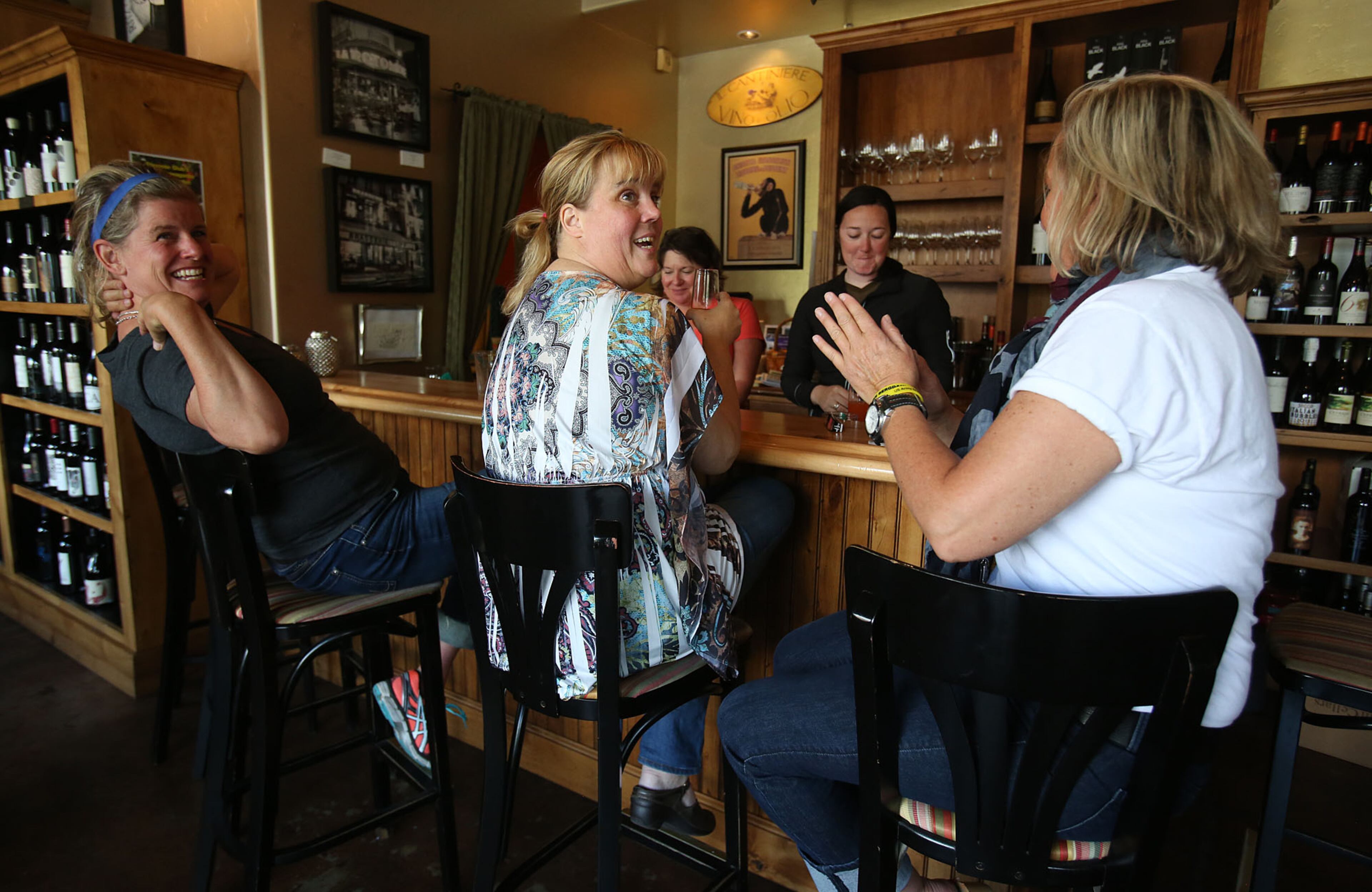 Lee McCune, right, talks with Sherry Horton, center, and Tanya Olson to celebrate the news of U.S. Army Sgt. Bowe Bergdahl's release on Saturday, May 31, 2014 in Hailey, Idaho, his hometown. Bergdahl, 28, had been held prisoner by the Taliban since June 30, 2009. He was handed over to U.S. special forces by the Taliban in exchange for the release of five Afghan detainees held by the United States. McCune, who knows Bergdahl, has worn yellow bracelets to show support during his captivity. (AP Photo/The Times-News, Ashley Smith)