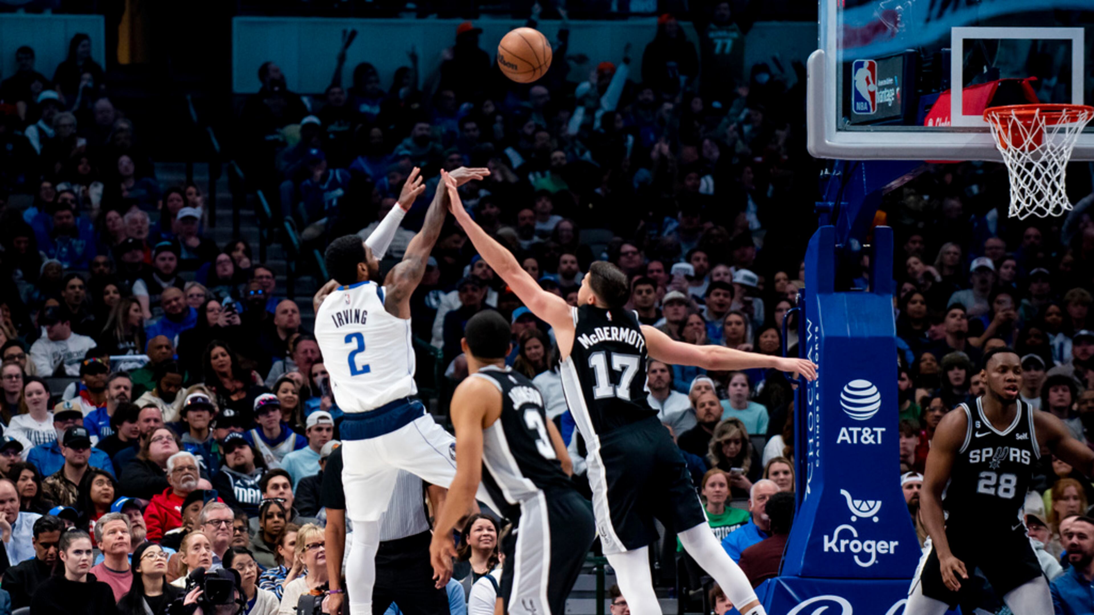 Dallas Mavericks guard Kyrie Irving (2) attempts a shot over San Antonio Spurs forward Doug McDermott (17) in the first half of an NBA basketball game on Thursday, Feb. 23, 2023, in Dallas. (AP Photo/Emil T. Lippe)