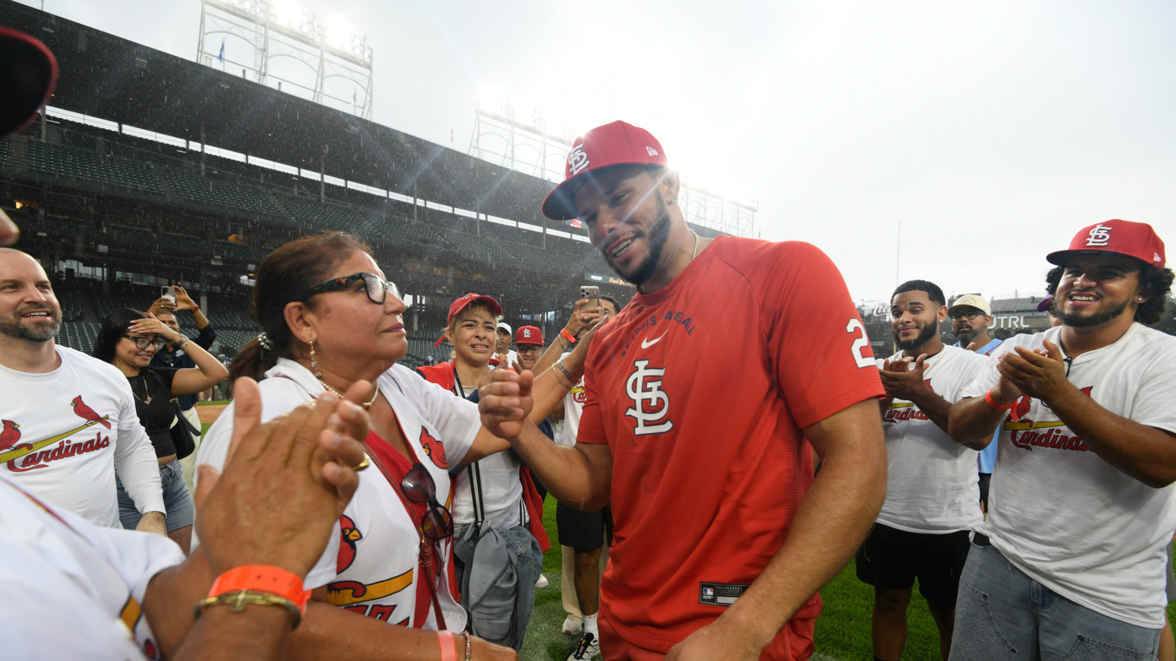 St. Louis Cardinals' Joshua Baez, right, celebrates with his mother Yris Carmen Baez, left, after defeating the Chicago Cubs in a baseball game in Chicago, Saturday, Aug. 15, 2026. (AP Photo/Paul Beaty)