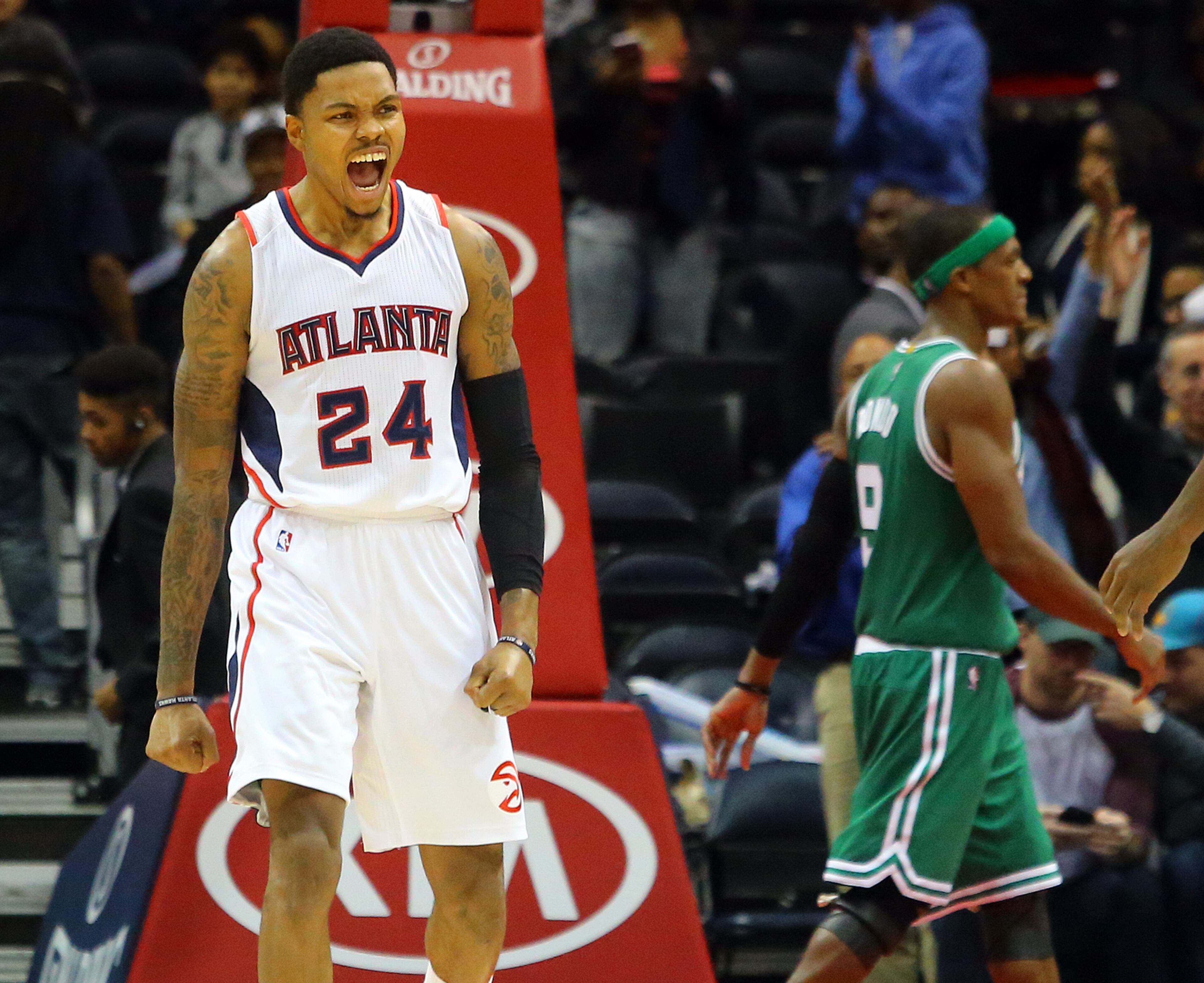 Hawks Kent Bazemore reacts to beating the Celtics 109-105 as Rajon Rondo walks off the court when time expires in an NBA basketball game on Tuesday, Dec. 2, 2014, in Atlanta. CURTIS COMPTON / CCOMPTON@AJC.COM