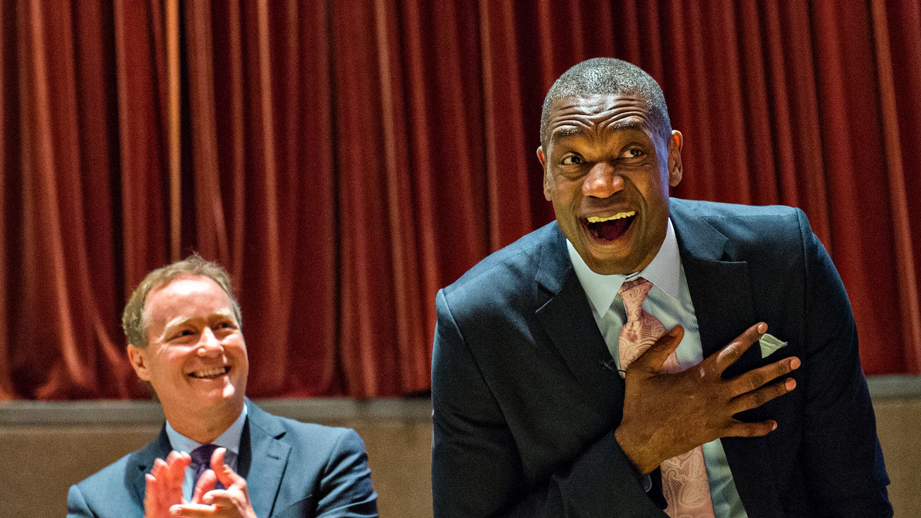 September 1, 2015 Atlanta - Dikembe Mutombo (right) reacts to the announcement that his jersey number will be retired on November 24 as Atlanta Hawks coach Mike Budenholzer claps during the celebration naming September 1 as Dikembe Mutombo Day in Fulton County at the Fulton County Government Center in Atlanta on Tuesday, September 1, 2015. JONATHAN PHILLIPS / SPECIAL