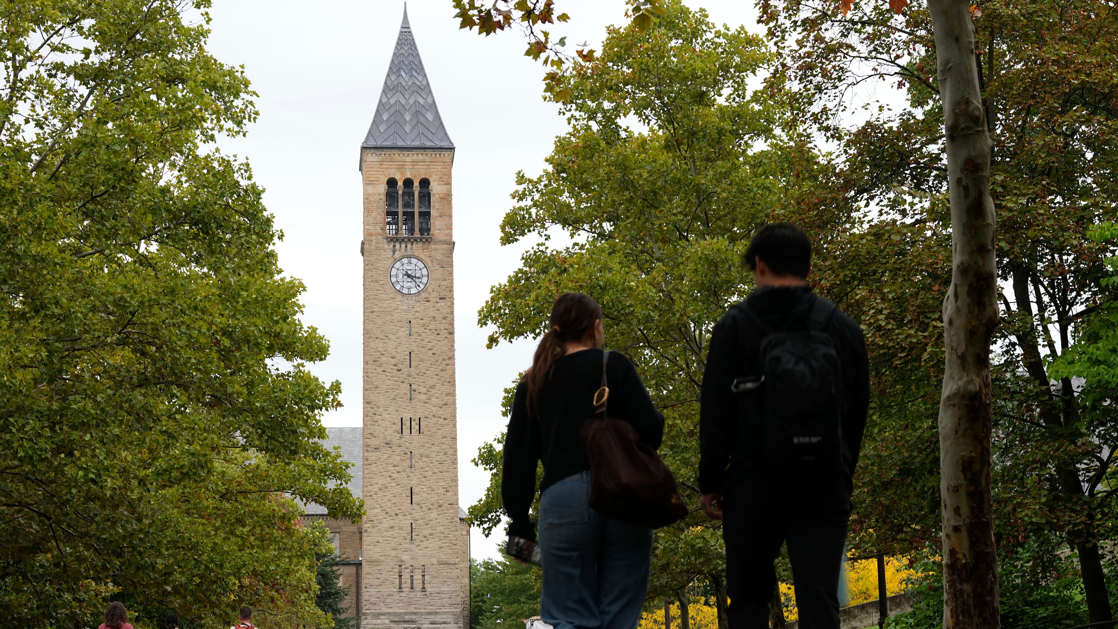 Pedestrians walk on the campus at Cornell University in Ithaca, N.Y., Thursday, Oct. 1, 2026. (AP Photo/Matt Rourke)