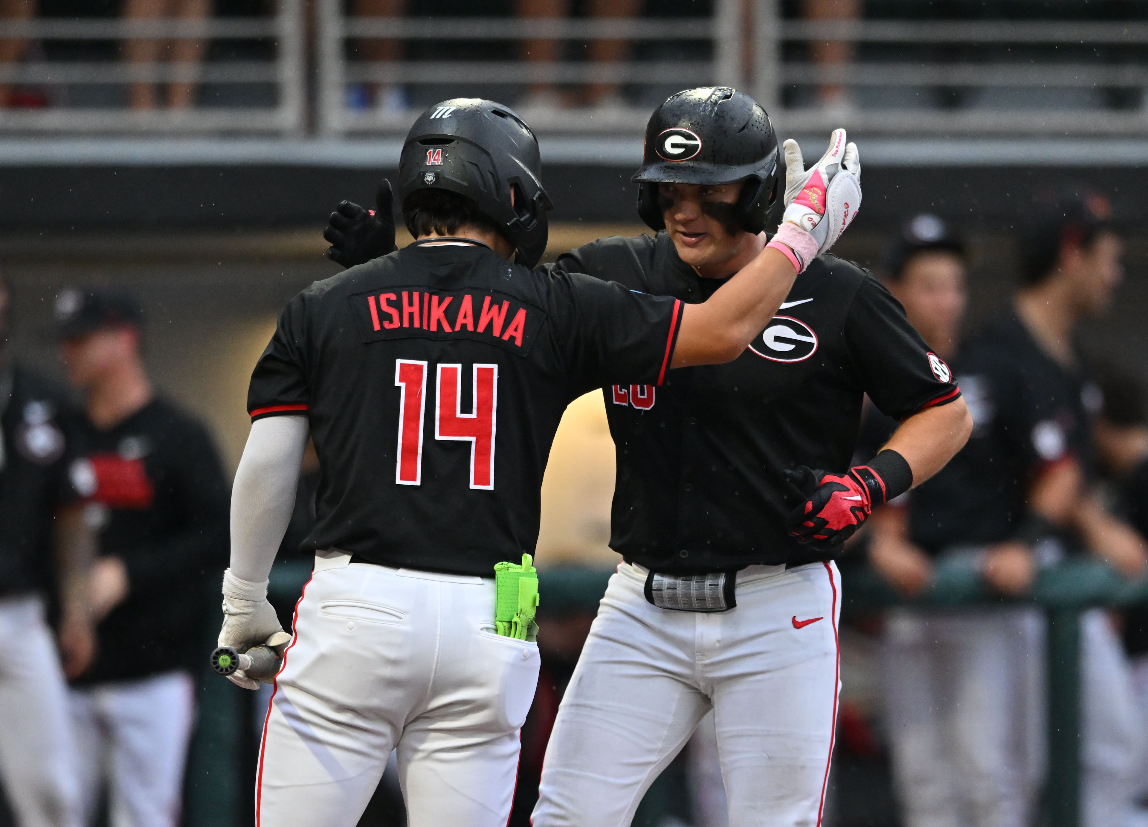 Georgia catcher Brennan Hudson (28) celebrates with Georgia utility Kenny Ishikawa (14) after hitting a solo home run during the fifth inning of their NCAA Regional game at Foley Field, Friday, May 29, 2026, in Athens. (Hyosub Shin/AJC)