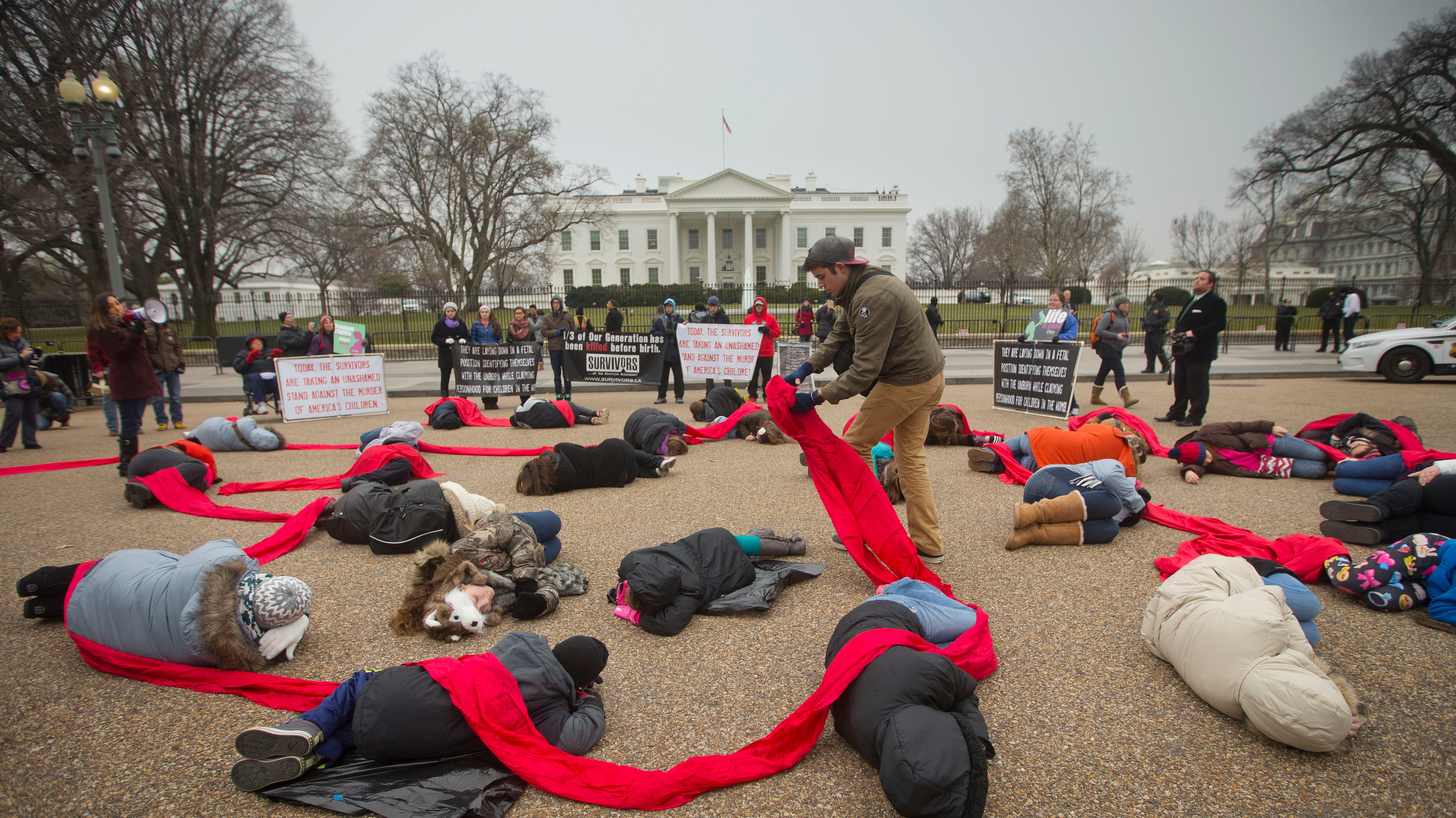 CORRECTS TO ANTI-ABORTION ACTIVISTS - Anti-abortion rights activists are connected with a red piece of cloth as they stage a 'die-in' in front of the White House in Washington, Wednesday, Jan. 21, 2015. Tomorrow marks the 42nd anniversary of the landmark 1973 Roe vs Wade decision and the March for Life, an annual gathering of abortion protest that dates back to 1974. (AP Photo/Pablo Martinez Monsivais) Anti-abortion rights activists are connected with a red piece of cloth as they stage a 'die-in' in front of the White House in Washington, Wednesday. (AP/Pablo Martinez Monsivais)
