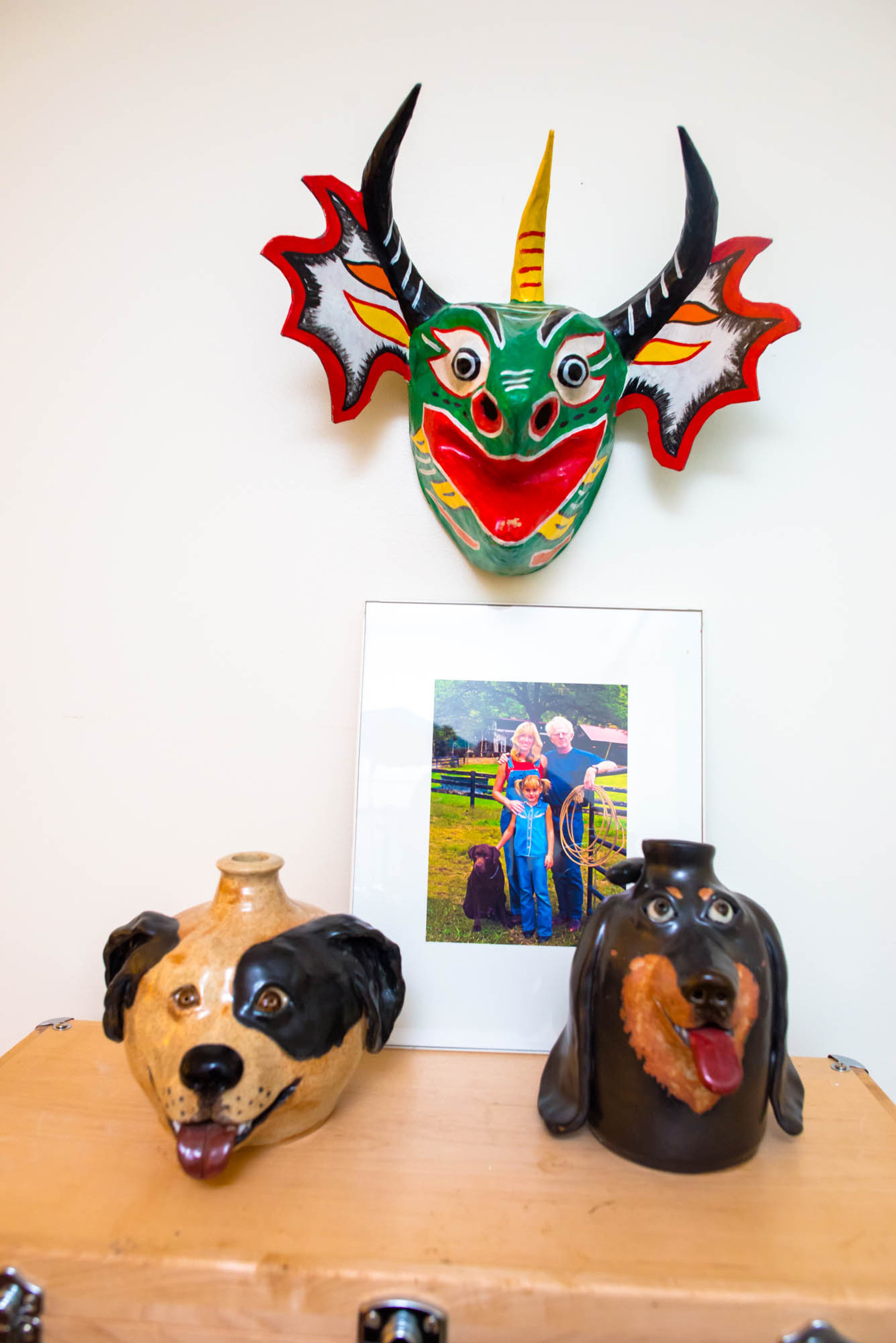 This mask was collected by Ron and Pippa Seichrist during their travels to Venezuela. Below the mask sit two dog jugs, which were handcrafted by Pip-pa. Text by Anna Logan/Fast Copy News Service.
