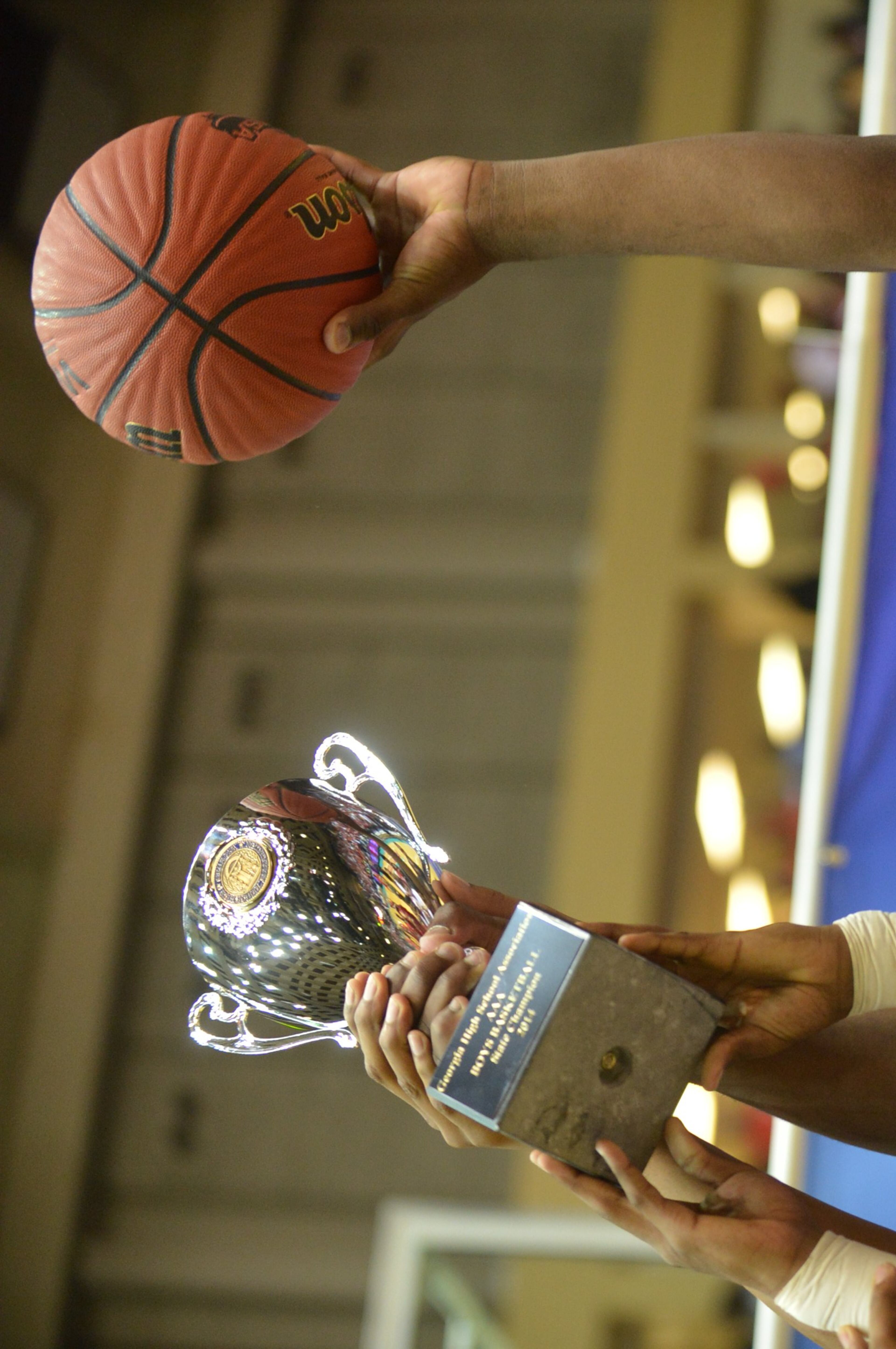 C.J. Thurman #1 hoists the game ball and championship trophy. Coverage of the Class AAA boys basketball championship between the Buford Wolves and Morgan County Bulldogs at the Macon Coliseum Saturday, March 8, 2014. Morgan County won handily, beating the Buford Wolves 69-45.