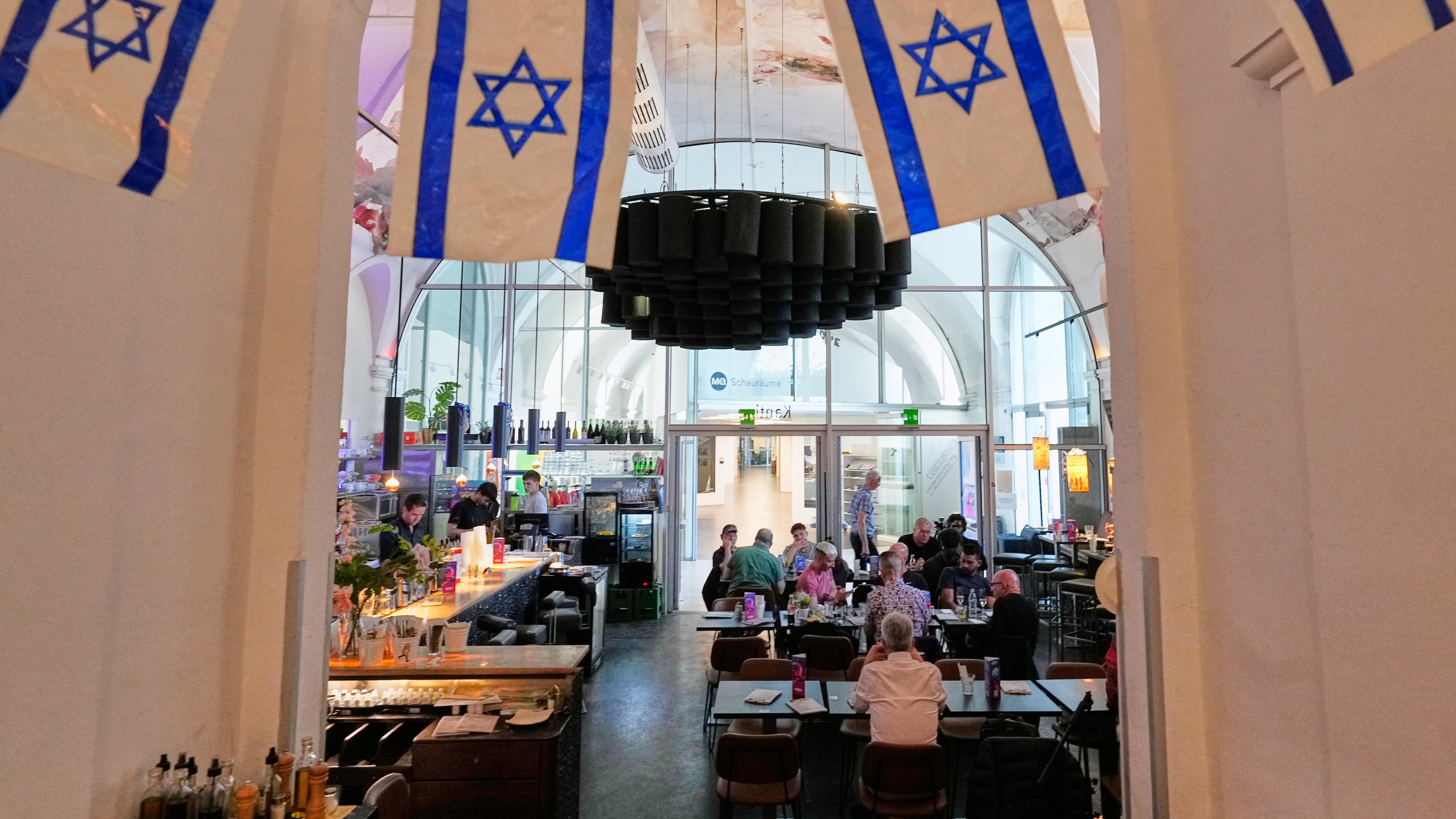 Israeli flags hang in the designated Israel "Euro Cafe" MQ Kantine during the 70th Eurovision Song Contest week in Vienna, Austria, Wednesday, May 13, 2026. (AP Photo/Martin Meissner)