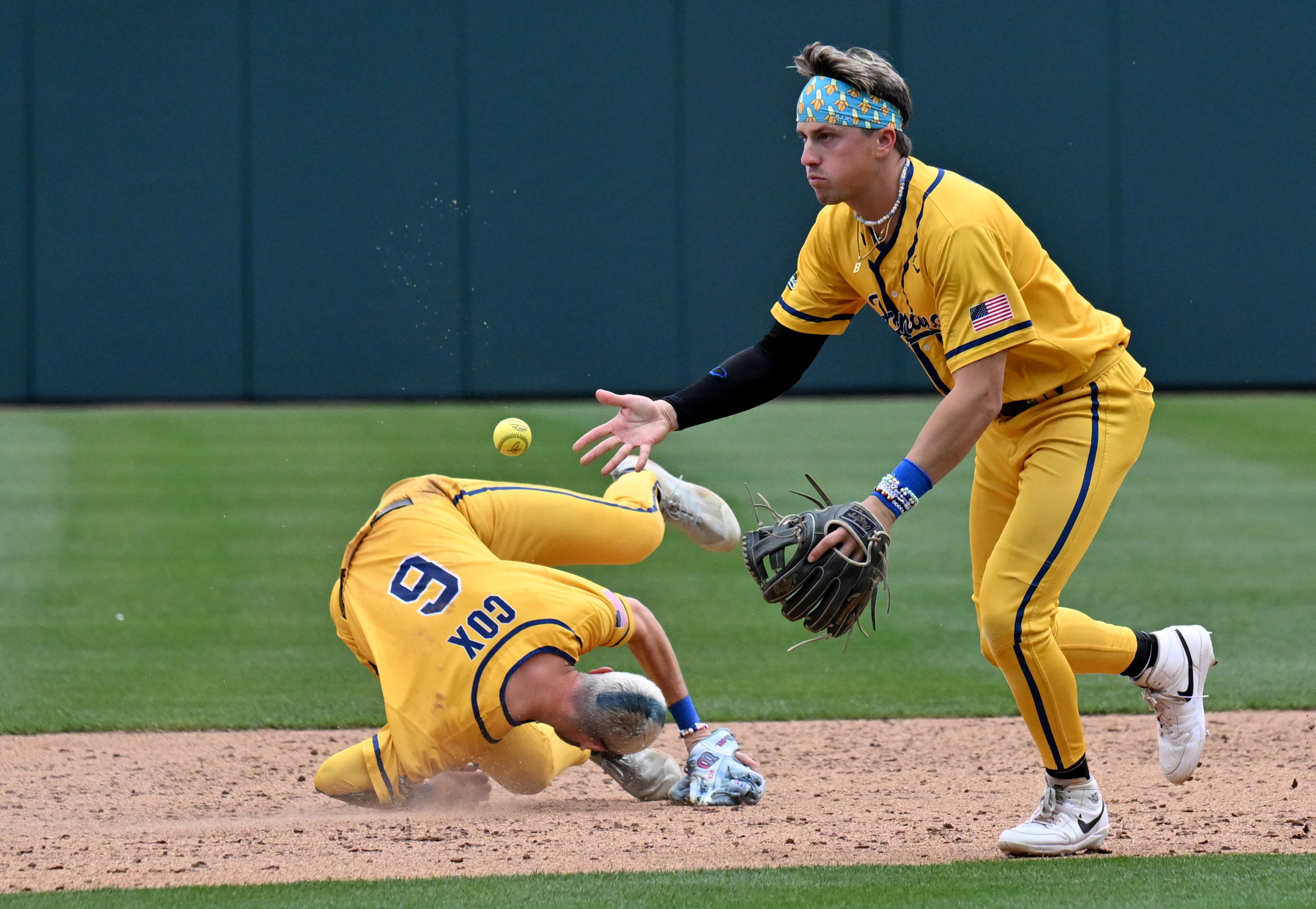 Savannah Bananas' Jackson Olson (right) tosses a ball to second base as teammate Ryan Cox tumbles. (Hyosub Shin / Hyosub.Shin@ajc.com)