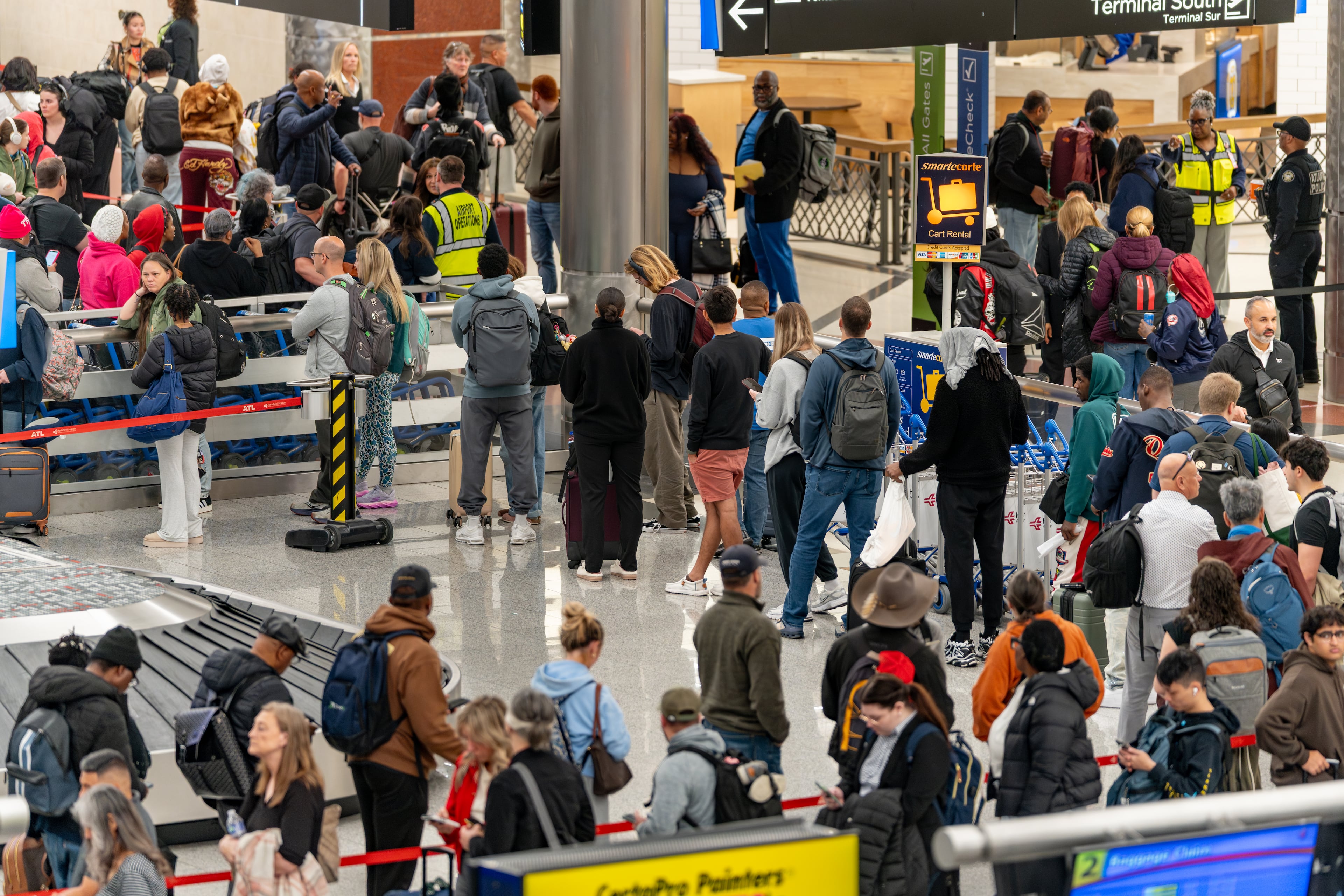 Travelers wait in long lines for the domestic north security checkpoint at Hartsfield-Jackson Atlanta International Airport on Monday. (Ben Hendren for the AJC)