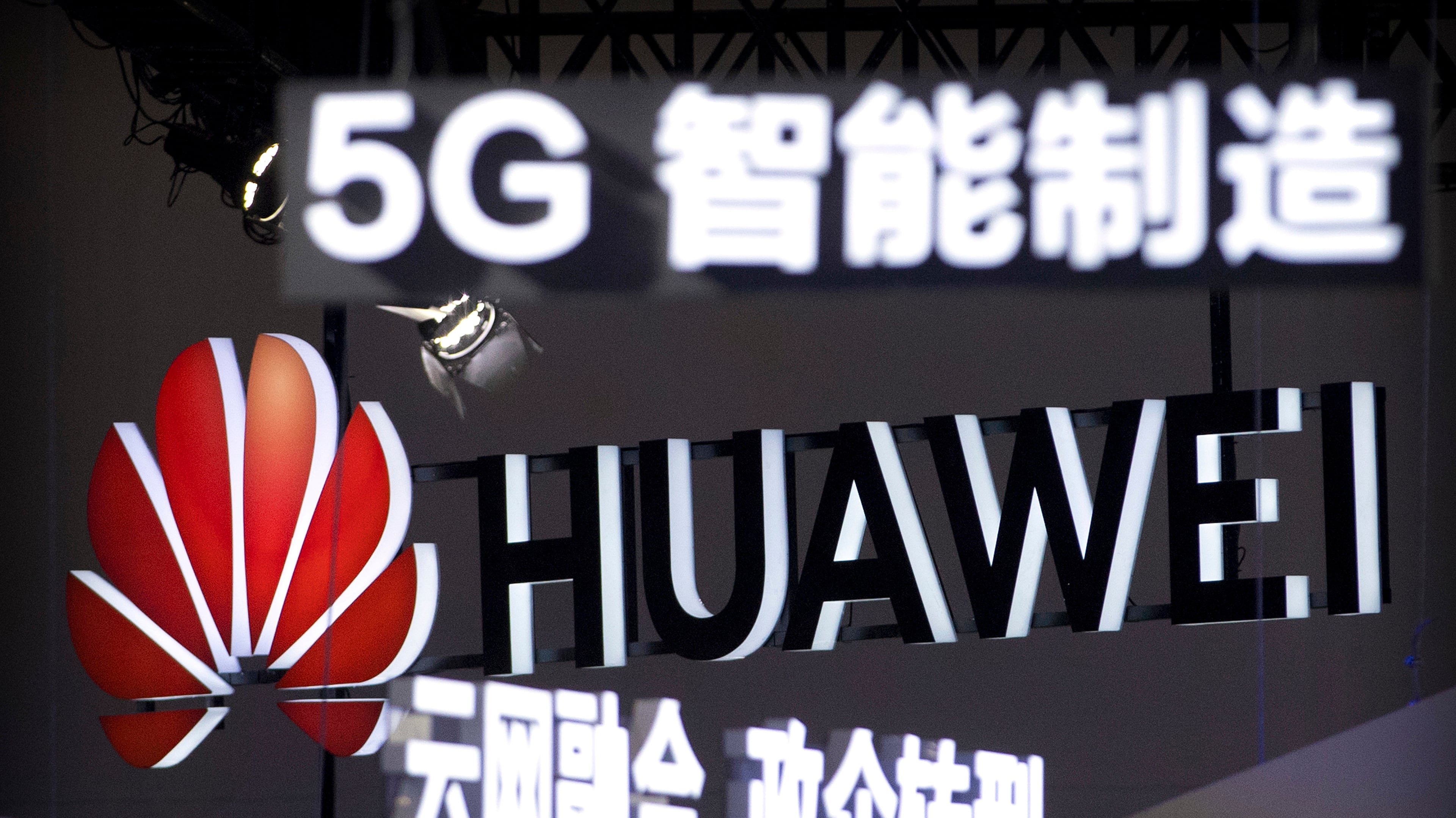 FILE - Signs promoting 5G wireless technology from Chinese technology firm Huawei are displayed at the PT Expo in Beijing on Sept. 26, 2018. (AP Photo/Mark Schiefelbein, File)