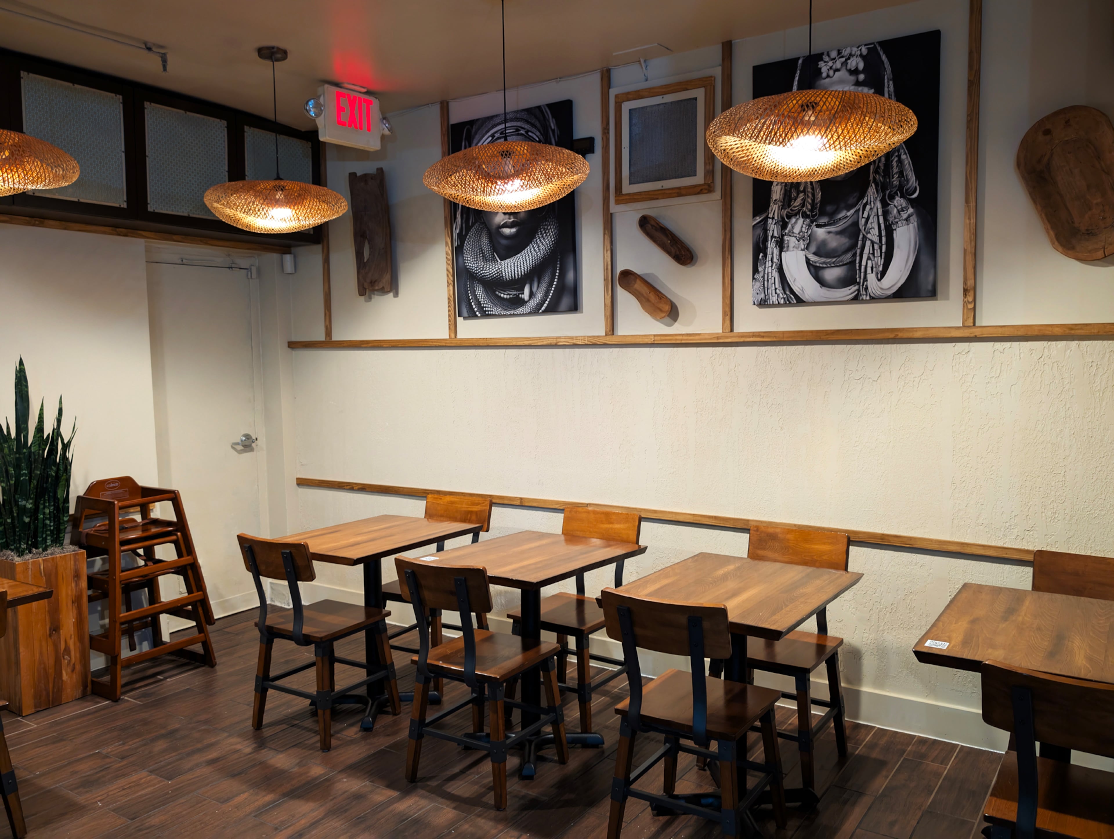 Coffee Therapy's interior includes a variety of cafe tables and booths and is decorated with large black and white portraits.