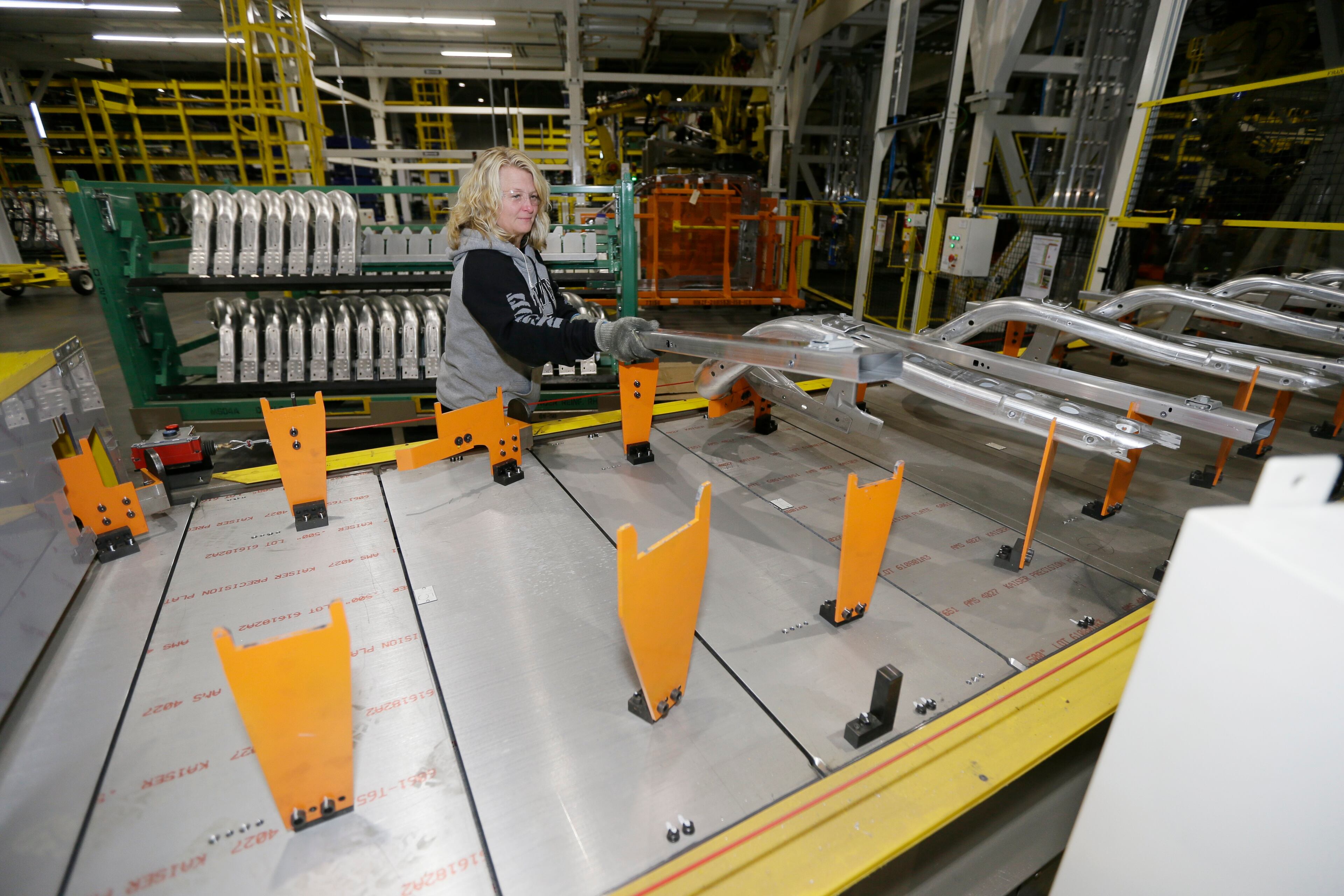 Jennifer Gillesbie works on the frame of the new Ford F-150 truck assembled at the Rouge Truck Plant in Dearborn, Mich. It's the automaker's biggest bet in decades: an aluminum-sided F-150 that could set a new industry standard _ or cost the company its pickup truck crown. It will arrive on U.S. dealer lots next month. Aluminum _ which is lighter than steel but just as strong _ isn't new to the auto industry, but this is the first time it will cover the entire body of such a high-volume vehicle. (AP Photo/Carlos Osorio)